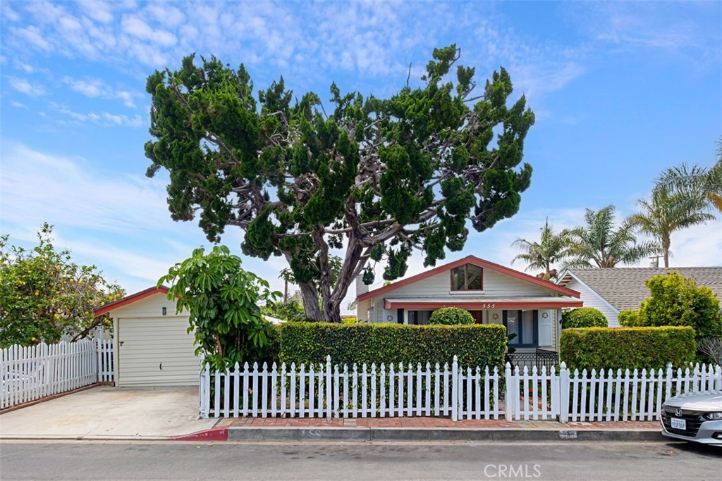 This classic 1924 cottage is a surprising oasis in central Laguna with walkable access to all of downtown’s activities, beaches and art galleries. Private gardens provide a lush outdoor background to entertain year-round in or just relax on the deck or patios overlooking the many succulents, flowers and fruit-bearing trees. Vintage home features include a brick fireplace, leaded glass cabinets, exposed beam ceilings, wainscoting and original garage with a driveway. The extra-large lot has wide frontage on both Through and Catalina Streets plus its R2 zoning offers valuable potential to expand the cottage, add another home, ADUs, or potentially subdivide the lot. For anyone wanting to be part of historic Laguna, this timeless cottage and its coveted location could be your special place!