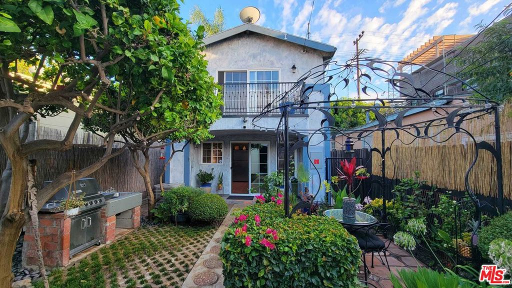 FULLY FURNISHED! Available 9/15/25 - Contemporary Mediterranean Home in Culver City! Charming and spacious two-story Mediterranean-style residence, offered fully furnished and ideally located in the heart of Culver City. Enter through a hedge-lined front gate into a private patio, where a rustic speakeasy door welcomes you into the open living room with tiled floors, leather furnishings, curated artwork, and a pebble mosaic fireplace. The country-style kitchen features granite countertops, checkered floors, and generous counter space, while the adjacent kitchen dining area offers an updated set with a modern touch. Upstairs, two bedrooms each enjoy their own balcony and hardwood floors. The primary bedroom overlooks the backyard garden, and the secondary bedroom--currently set up as an office--can also be used as a guest room. The backyard is designed for entertaining with an enclosed garden, gazebo, mature landscaping, and a built-in BBQ. A two-car garage provides direct access to the yard and home. Additional features: Solar panels for energy efficiency. Alarm system. Small dog considered. Located within walking distance to downtown Culver City's theaters, farmers market, restaurants, bars, yoga studios, and shops. A welcoming neighborhood with a true community feel.