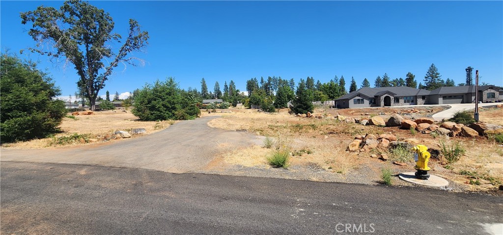 Nestled in the serene town of Paradise, California, this .26-acre lot offers a unique opportunity to build your dream home in a peaceful, picturesque setting. Located on a quiet cul-de-sac, this property ensures privacy and minimal traffic, perfect for those seeking a tranquil lifestyle. This prime parcel is a blank canvas, ready for you to create a custom home tailored to your vision. Whether you’re dreaming of a cozy retreat or a modern masterpiece, this lot’s size and location offer flexibility for a variety of architectural styles. The cul-de-sac setting ensures a peaceful ambiance, perfect for families, retirees, or anyone looking to enjoy the charm of small-town living with the beauty of Northern California’s landscape. Explore nearby Bidwell Park, one of the largest municipal parks in the U.S., offering hiking, biking, and outdoor adventures. Enjoy the vibrant community of Paradise, known for its friendly atmosphere and local events. Quick access to Chico for additional dining, shopping, and entertainment options. Don’t miss this chance to own a piece of Paradise!