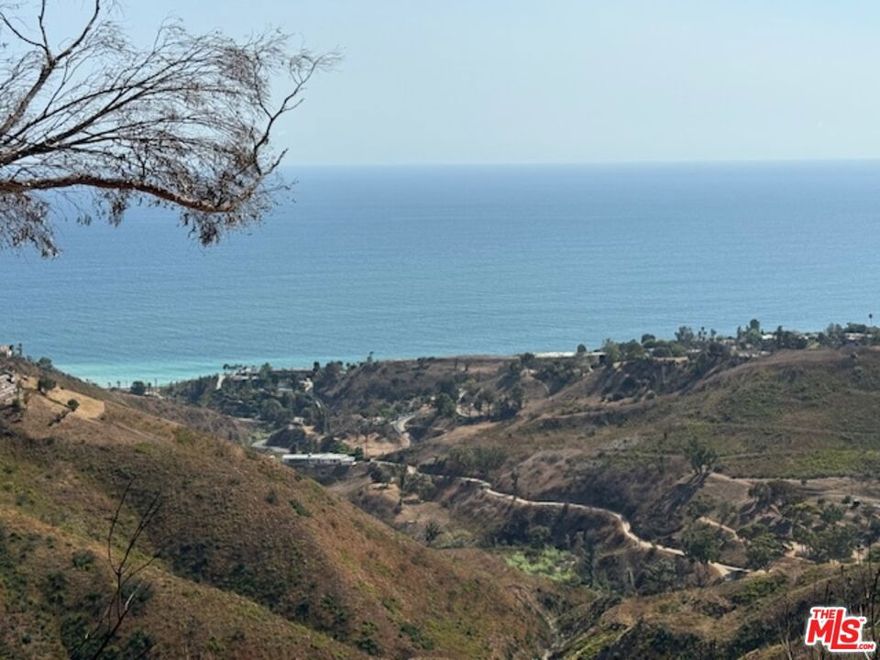 FIRE REBUILD LOT | Wide Open Ocean Views | Rambla Pacifico.      Opportunity knocks in one of Malibu's best-kept secrets. A cool, under-the-radar neighborhood with unbeatable ocean views and unmatched privacy. This FIRE REBUILD LOT offers wide open, unobstructable whitwater views of Surfrider Beach and Malibu Colony. Tucked away at the very end of Eldermore Drive, this lot offers ultimate seclusion while still carrying a prestigious Rambla Pacifico address. All the privacy you could ask for, with a view that will never be taken away. Rebuild rights include 1,578 sq ft + 10% and the potential for an ADU, making this one of the most affordable buildable lots in the area with existing rights in place. Whether you're looking to build your Malibu dream home or create a smart investment, this is a rare find at an unbeatable price. Don't miss the chance to build new in a peaceful coastal enclave. This is likely the lowest priced lot with fire rebuild rights currently available in Malibu