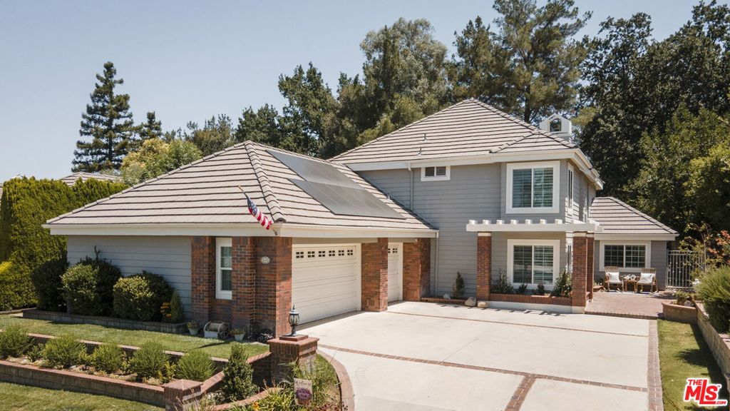 Located in one of the most sought-after neighborhoods in the Santa Clarita Valley, the Valencia Summit, this stunning residence is one of the largest homes in the community. Boasting excellent curb appeal, the beauty continues as you step through the newly installed double doors with custom hardware into a grand and welcoming entry.The main level features wide plank flooring throughout and a beautifully updated staircase with elegant new iron banisters. The fully remodeled kitchen showcases sleek quartz countertops, stylish cabinetry, and stainless steel appliances, and opens to a spacious family room complete with a custom-built entertainment center and a striking fireplace.Ideal for entertaining, the home also includes a formal dining room and a large office with custom built-in shelving. Downstairs, you'll find a private in-law or guest suite with a renovated full bathroom, along with an additional office/flex space.Upstairs offers two generous secondary bedrooms and a luxurious primary suite featuring vaulted ceilings, a sitting area, dual closets, and a spa-inspired ensuite bath that has been impeccably remodeled. Every bathroom in the home has been upgraded with new cabinets, quartz countertops, stylish mirrors, and high-end finishes.Additional highlights include newer dual-pane windows, plantation shutters, ceiling fans, closet organizers, a spacious 3-car garage, new 200-amp electrical panel, copper plumbing, and a low-maintenance backyard with a brand-new built-in BBQ center. The home is also equipped with PAID solar panels, offering energy efficiency and long-term savings.Residents of the Valencia Summit enjoy access to scenic Paseo trails, four pools and spas, a clubhouse, tennis and pickleball courts, lush greenbelts, and picnic/BBQ areasall with a low HOA and no Mello Roos.Truly move-in ready, this exceptional home is a must-see.