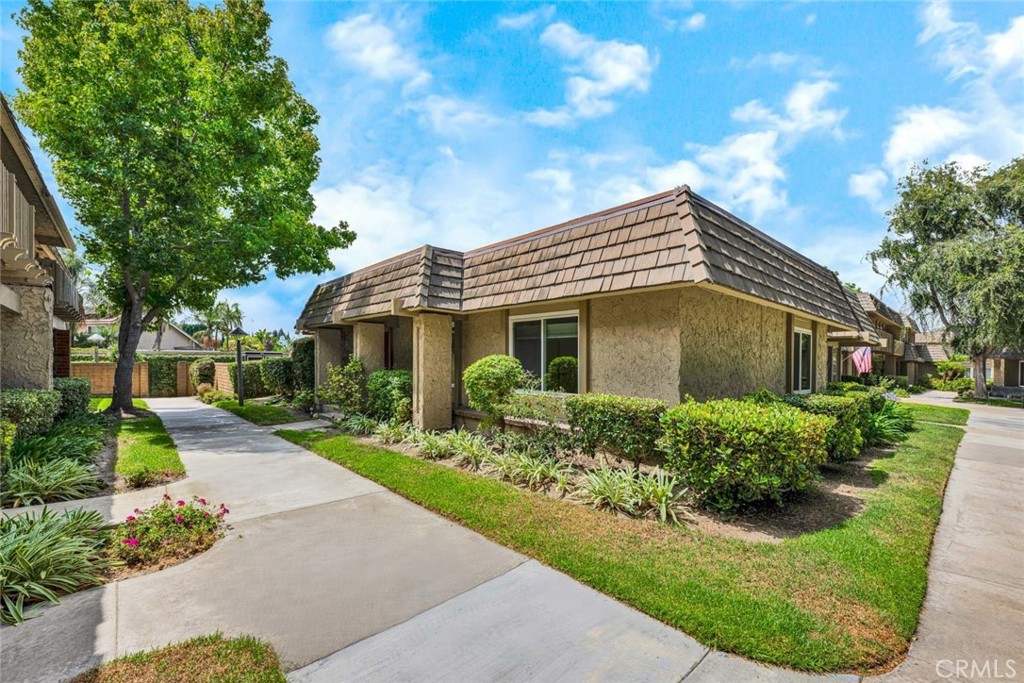 Welcome to Tiburon South, a park like community with winding roads, mature trees and an abundance of green spaces. Located in a prime location in the complex, this highly sought after single story Malibu model end unit feels like a single family home, with only one shared wall and no one above or below. Boasting double paned windows with custom window coverings, central air conditioning, new carpeting in the bedrooms and fresh paint, this great home is waiting for someone to make it their own. The living space wraps around the kitchen which is separated from the living space with a breakfast counter. A sliding door opens to an oversized private patio with a custom planter and 2 car garage with washer and dryer included. This home was converted from 3 bedrooms to 2, so the living area is spacious with room for an office or play space with a built in storage cabinet. The primary suite window looks out to a large wooded lawn, lending to the serenity of the location. Tiburon offers its residents 5 swimming pools, 2 clubhouses, 2 tot lots and an abundance of lawns and greenbelts. Conveniently located just south of 405 freeway, near shopping strips and restaurants, Mile Square Park recreational facilities, golf courses, Orange Coast Memorial Hospital and is only about 5 miles from the beach. All this and award winning Fountain Valley School District.