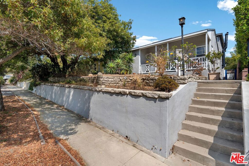 Attention flippers and "add value" buyers. This perfectly located Mar Vista hill home north of Palms with an ocean view from the primary suite is begging to be restored. Down stairs are 2 bedrooms and 1.5 baths, living room, dining area, family room, kitchen and a bonus space with plumbing. Add a wall and it can become an easy secondary living space. Upstairs is the primary suite with an office area built into a huge walk-in closet space. Bring your designer and come up with the best of many options. The back alley opens an option to build an ADU with direct access, or convert the existing garage leaving more room for a pool to to expand the existing foot print.
