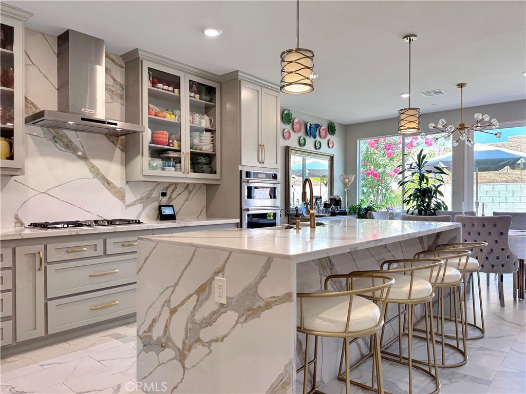 Here’s your opportunity to own a stunning, move-in-ready smart home located in one of the area’s most sought-after communities. This meticulously maintained residence offers 4 spacious bedrooms, 3 full bathrooms, and over $100,000 in high-end upgrades throughout. Step inside to a bright, open-concept floor plan featuring gorgeous upgraded flooring, plantation shutters, custom paint, built-in cabinetry, and recessed lighting. The heart of the home is a beautifully designed kitchen with rich cabinetry, custom lighting, a large center island, and stainless steel appliances including a double oven, built-in cooktop, microwave, and dishwasher. Adjacent to the kitchen is a warm and inviting living room with custom built-ins, a cozy fireplace, and sliding glass doors that lead to your private backyard—perfect for relaxing or entertaining. Downstairs, you'll find a full bedroom and bathroom, ideal for guests or multi-generational living. Upstairs, the luxurious primary suite offers a spa-like ensuite bath complete with a walk-in shower, soaking tub, dual vanities, and an oversized walk-in closet. The additional bedrooms are generously sized, and the upstairs windows offer breathtaking views of rolling hills and mountains. Enjoy the convenience of an indoor laundry room with built-in shelving, as well as a low-maintenance front and backyard, perfect for year-round enjoyment. The attached 2-car garage and extended driveway provide ample parking and storage space. This is more than just a home—it's a lifestyle. Don’t miss your chance to live in this highly desirable community with easy access to parks, shopping, and top-rated schools.