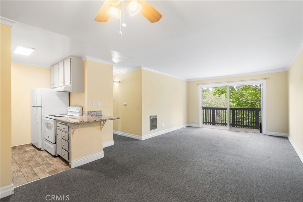 Welcome to this inviting 1-bedroom, 1-bath condo in the sought-after The Estates community of Rolling Hills Estates. Situated on the top floor, Unit #317 offers privacy, tranquil greenery views, and a spacious open layout perfect for comfortable living or a stylish retreat. Step inside to discover a bright living space with fresh interior paint, crown molding, and direct access to a peaceful private balcony—ideal for morning coffee or sunset relaxation. The kitchen features granite countertops, classic white appliances, and a convenient breakfast bar that flows into the living area. The generously sized bedroom offers great natural light and a large closet, while the updated bathroom includes a modern vanity, granite counters, and a full tub/shower combo with grab bars for accessibility. Additional highlights include newer flooring in the kitchen and bath, ceiling fan, and extra storage. Residents enjoy access to resort-style amenities: lush landscaping, sparkling pool and spa, sauna, tennis courts, fitness center, and a community clubhouse. Located just minutes from shopping, restaurants, nature trails, and award-winning Palos Verdes schools. Whether you're a first-time buyer, investor, or downsizer—this is the perfect blend of convenience, value, and location.