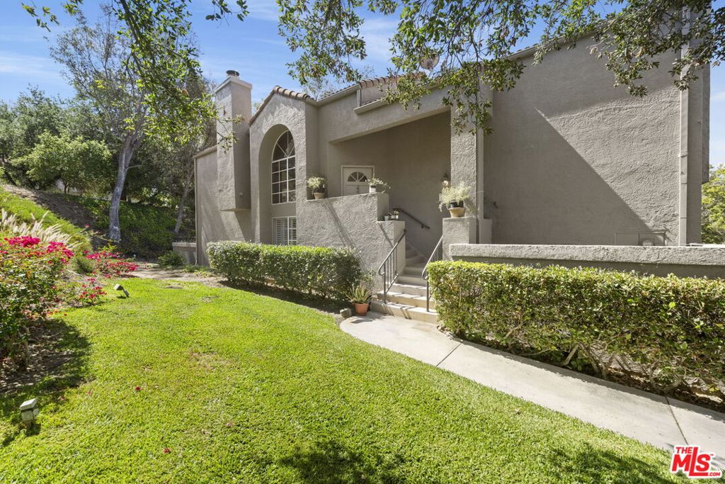 Completely reimagined, this 3 bedroom, 2.5 bathroom end unit townhome is located in the highly desirable community of Cal West. The tranquil and private unit features high ceilings, plantation shutters and natural light flooding throughout. The main level boasts an open living room with fireplace, soaring windows and sliding glass door to a private balcony. Kitchen opens to the large formal dining area. The primary bedroom has vaulted ceilings, walk-in closet and primary bath with dual sinks and shower. Downstairs, there is an additional family room with two secondary bedrooms and a full bath with dual sinks and shower/bathtub. Both secondary bedrooms downstairs have sliding doors with access to a large and private entertainer's patio with views of the surrounding picturesque rocky mountainside. Guest powder bathroom, in-unit laundry, alarm system, ceiling fans, two car attached/direct access garage with built-in cabinets, plenty of guest parking just steps from the unit and conveniently located close to pool, security office and amenities. The area surrounding Cal West is protected as park area and provides hiking and biking trails and other outdoor activities and is also known for its beauty and rich Hollywood history. This is truly one not to be missed!