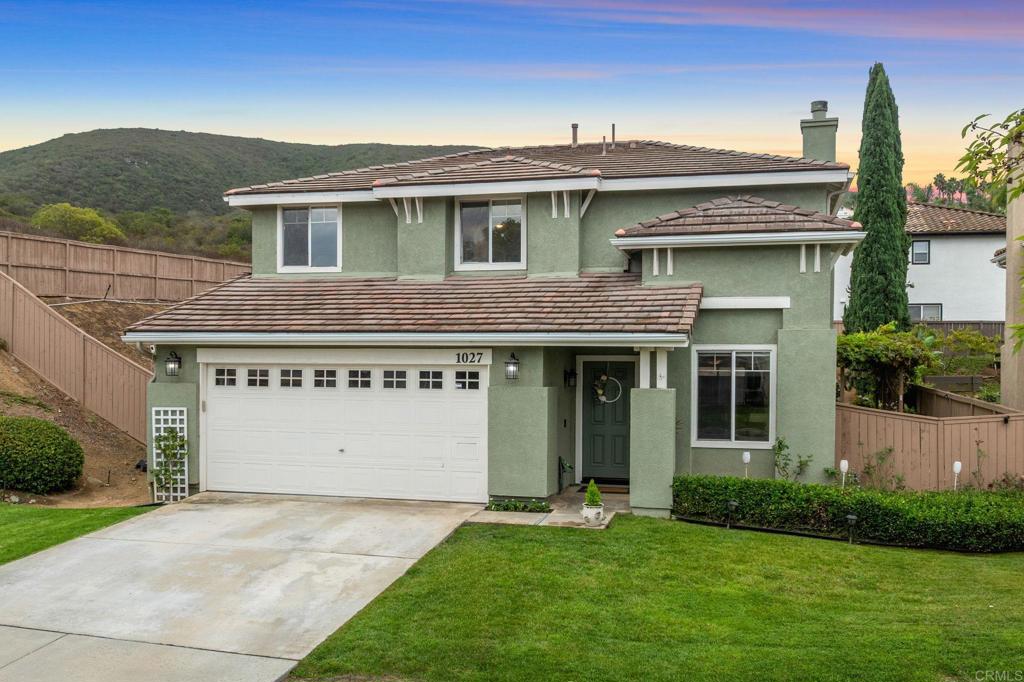 Welcome to 1027 Cima Drive in the coveted Discovery Hills community of San Marcos! This beautifully remodeled 3 bedroom, 2.5 bath home has been lovingly maintained by its original owners and sits on an expansive 9,216 sq. ft. lot. A versatile loft adds flexibility perfect for a home office, playroom, or easily converted into a 4th bedroom. Bathed in natural light, the home offers both a formal living room and a cozy family room with fireplace. The heart of the home is the stunning remodeled kitchen, showcasing white cabinetry, quartz countertops, a spacious peninsula that functions like an island for additional prep and dining space, a walk-in pantry, and stainless steel appliances. Recent updates include new flooring, fresh interior and exterior paint, rain gutters, new blinds, and a new roof underlayment that extends the roof’s lifespan making this home truly move-in ready. The spacious backyard is an entertainer’s paradise with room to relax, play, or gather, and features a bounty of fruit trees including avocado, citrus, pomegranate, and loquat, along with a lush grape arbor. Ideally located in a well-kept neighborhood with no HOA, this home is just minutes from Discovery Lake, Lake San Marcos, top-rated schools, scenic hiking trails, Cal State San Marcos, the new Kaiser Hospital, and upscale shopping and dining. This Discovery Hills gem combines space, upgrades, and location. It’s the home you’ve been waiting for!