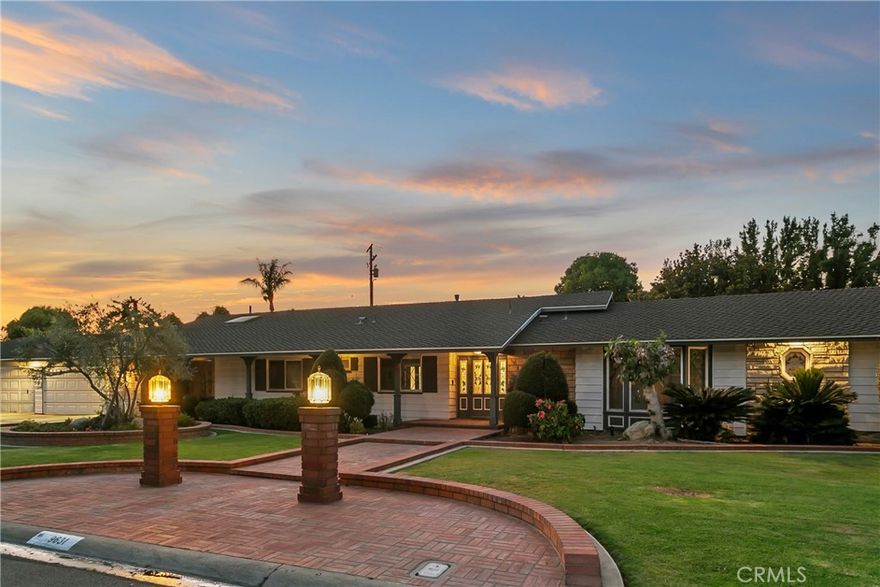 With one of the most commanding and impressive frontages to hit the market in years, this single-story ranch style gem sets the bar for Villa Park luxury living. Sitting on an elevated lot and boasting over 200 feet of frontage, this home stands alone when it comes to street presence. Enter through customs lead glass front doors to an elegant foyer and spacious great room. Stone finished floors, custom crown, stone base, neutral tones and open concept give this entry a warm and inviting feel. Gourmet kitchen is a culinary dream, complete w/ two tone custom cabinets, sprawling island w/ prep sink & bar top seating, dual farm sinks, high end SS appliances, double oven, 6 burner professional cooktop, custom hood, and scenic views of the sprawling back yard. Great room is open and expansive w/ large dining table space, glass inlaid custom hutch, and spacious & family room. The den/living room is a throwback to when craftsmanship mattered. Finished with floor to ceiling finished carpentry, architectural exposed beams, elegant and stylish built in bar, and stone finished fireplace wall w/ built in TV. Primary bedroom is HUGE and enjoys lots of natural light from an impressive lead glass inlaid front window. Large dual paned slider has easy access to spacious side yard. The primary bath was recently renovated with floor to ceiling porcelain, free standing soaking tub, dual vanity sinks w/ stone counters, dam free walk-in shower w/ rain head, custom fixtures, and a large walk-in closet.  The spacious laundry has waterfall stone counter washer and dryer enclosure, custom cabinets w/ lots of upper cabinet storage and HUGE overflow pantry for kitchen or linen storage. Secondary bedrooms are open and spacious with custom base and case, neutral tones, and scenic picture windows. All secondary baths have been recently renovated and upgraded and are appointed with high end stone finishes, elegant cabinetry, custom fixtures, and functional layouts. The backyard boasts a sprawling layout with multiple areas for enjoyment OR expansion. An expansive patio cover, complete with custom pillars, ceiling fans, and recessed lighting gives way tons of grass and room to run. Raised garden beds are perfect for green thumb enthusiasts. Other features include 4 car garage, ceiling fans, window coverings, separate family room access, newer doors and windows, brick finished hardscapes, mature trees, covered front porch and so much more!  Call immediately for more details!