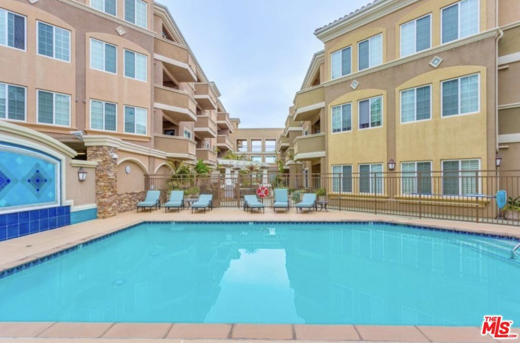 Welcome to Breakwater Village, a premier 55+ community in the heart of Redondo Beach. This bright and private 1-bedroom, 1-bath corner unit offers 790 square feet of comfortable living with an open floor plan, plush carpeting, and abundant natural light. The well-appointed kitchen features granite countertops, oak cabinetry, stainless steel appliances, and a breakfast bar overlooking the living area.Enjoy seamless indoor-outdoor living with direct patio access from both the living room and bedroom ideal for morning coffee or outdoor dining. Additional features include an in-unit washer/dryer, gas grill, and assigned parking. The community is fully wheelchair accessible and includes exceptional amenities: a resort-style pool, gym, movie theater, clubhouse, secure dog run, guest parking, and on-site management.Located near shops, restaurants, entertainment, and the beach this home offers a lifestyle of ease, convenience, and connection.