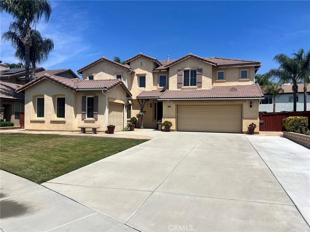 Absolutely beautiful 5 bedroom, 3 bath home in immaculate condition inside and out! Wonderful floorplan with large island kitchen with lots of storage and custom pull out cabinetry throughout. Large indoor laundry with even more storage off kitchen. Also, just off the kitchen and laundry is built-in desk area and exit to separate 3rd car garage/workshop. Additionally the downstairs boasts a formal living/dining area and lovely family room with fireplace. There is also a downstairs bedroom and bath. The upstairs is spacious and has 4 bedrooms, 2 baths and a large loft area. The secondary upstairs bath is newly remodeled with walk-in shower. Lots of custom storage upstairs as well. Upgraded LPV flooring throughout, whole house fan and dual air conditioning units. The yard is beautifully landscape and low maintenance. Huge covered patio with outdoor fans. Perfect yard for entertaining. Attached garage with epoxied floors and built in cabinets. The pride of ownership is evident throughout. Show your fussiest of buyers!