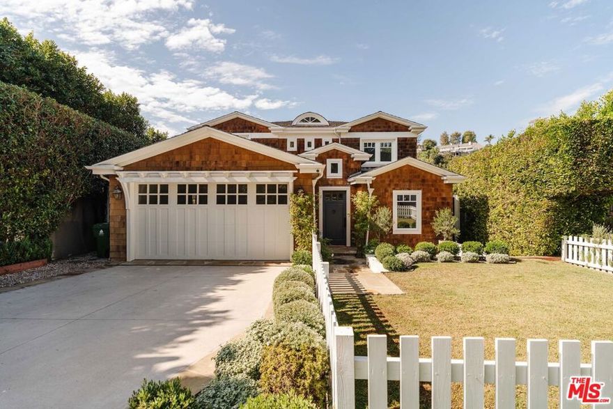 Set on a picturesque tree-lined street in the coveted Santa Monica Canyon, this private Traditional home blends modern luxury with timeless design across a thoughtful floor plan. Guests are welcomed through a gated, grassy front yard into a stately foyer with vaulted ceilings and a striking capiz shell chandelier. Hardwood floors lead past the formal living and dining rooms to the open-concept heart of the home - featuring a family room with fireplace and chef's kitchen boasting a large island, Viking appliances, and an adjacent breakfast area. French doors open to a tranquil backyard ideal for al fresco dining, lounging, and play. A butler's pantry and walk-in pantry connect the kitchen to the dining room. Completing the main level are a guest suite, office with built-ins, powder room, laundry room, and two-car garage. A dramatic, light-filled staircase leads to four bedroom suites upstairs. The luxurious primary suite features vaulted ceilings, a generous walk-in closet, private covered terrace with fireplace, and a spa-like bath clad in Arabescato marble with dual vanities, a large shower, and a soaking tub. All three upstairs bedrooms are ensuite with two sharing a jack-and-jill bathroom. A homework/desk area and built-ins/storage complete this level. Located within the Canyon Elementary School District, tenants also enjoy the best of the Canyon lifestyle with a short stroll to Rustic Coffee, the Santa Monica Stairs, and neighborhood favorites like Giorgio Baldi, Caff Delfini, and the Golden Bull - plus the beach just a few blocks away. Experience refined comfort and exceptional design on one of Santa Monica Canyon's most desirable streets. Home may be leased furnished - call listing agents for details.