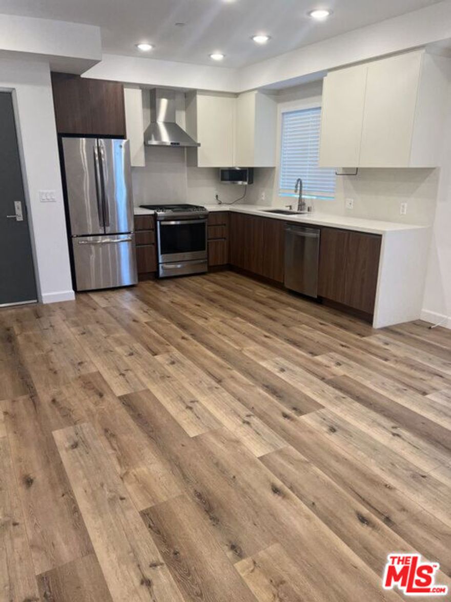 Welcome to Glenville Villas, a newer modern luxury apartment building on the Westside offering high-end design, premium finishes, and exceptional indoor-outdoor living. Unit 101 is a highly desirable residence featuring a private patio, automatic motorized shades, and abundant natural light throughout an open-concept floor planperfect for entertaining or working from home.The Brazilian-designed kitchen showcases modern Brazilian cabinetry, quartz stone countertops, a full quartz backsplash, stainless steel appliances, and a spacious peninsula ideal for cooking, dining, and hosting. The living area flows seamlessly to the private outdoor patio, creating a true extension of the living space.The bedroom features custom high-quality Brazilian closets, refined woodwork, and a sleek modern aesthetic. Additional highlights include LED lighting, in-unit washer and dryer, central HVAC, and contemporary finishes throughout.Residents enjoy access to a beautiful rooftop deck with lounge furniture, tables, and south-facing city views. Ideally located within walking distance to shops, cafs, markets, and restaurants along Pico Blvd, with a short walk to Beverly Dr and Beverly Hills dining and retail.Parking included, with EV charging available.Easy to show by appointment. Pet inquiries welcome.