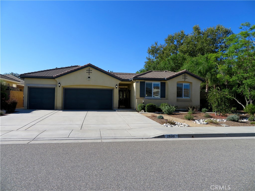 Welcome to this unique home at 29301 Lake Hills Drive. Menifee, CA 92585, a beautifully maintained single-story home offering comfort and style. Set on a generous 9,583-square-foot lot, 2,196-square-foot of living space and was built in 2005.This home features three spacious bedrooms plus a bonus room that can serve as a fourth bedroom or home gym. The open floor plan boasts high ceilings, recessed lighting, large windows, and a charming center courtyard that fills the home with natural light. The kitchen is a chef’s dream with a granite center island, upgraded stainless steel appliances including a double oven, microwave, refrigerator, and a walk-in pantry. The open family room includes a cozy fireplace and expansive views of the backyard through large windows. The home also features a low-maintenance front yard, offering curb appeal without the hassle. This home offers a private retreat, perfectly blending comfort with nature. Situated next to a scenic pathway, you can enjoy peaceful walks just steps from your door and walking distance to the serene lake. The spacious master bedroom is a true sanctuary, featuring a large walk-in closet, a separate jetted soaking tub, and a luxurious glass-enclosed steam shower. Two additional bedrooms offer ample natural light with large windows overlooking the street. The home also includes an inside laundry room, a three-car garage with a water softener system and paid solar panels. The essential appliances like the refrigerator, stove, microwave, washer, and dryer—all staying with the home for your convenience. Step outside to an entertainer’s dream backyard featuring a covered California room-style patio, a big water fountain, a cozy gazebo, and a stone-built barbecue perfect for gatherings. The yard offers fruit trees, grapevines, wooden garden boxes, and a low-maintenance full sprinkler and drip irrigation system. This home has home surge protection, fireguard protection breakers to protect the home circuits, heating and air conditioning is provided by 5-ton heat pump. Expanded solar capacity to include additional panels and 2 Tesla batteries. Limit of 5% yearly growth of energy bills starting under $200/month. Beyond this property, enjoy the resort-style amenities of this beautiful Heritage Lake Community, including 25 acres of lake with paddle boats and catch-and-release fishing, two junior Olympic swimming pools, a clubhouse, and waterfront walking, jogging, and parks.