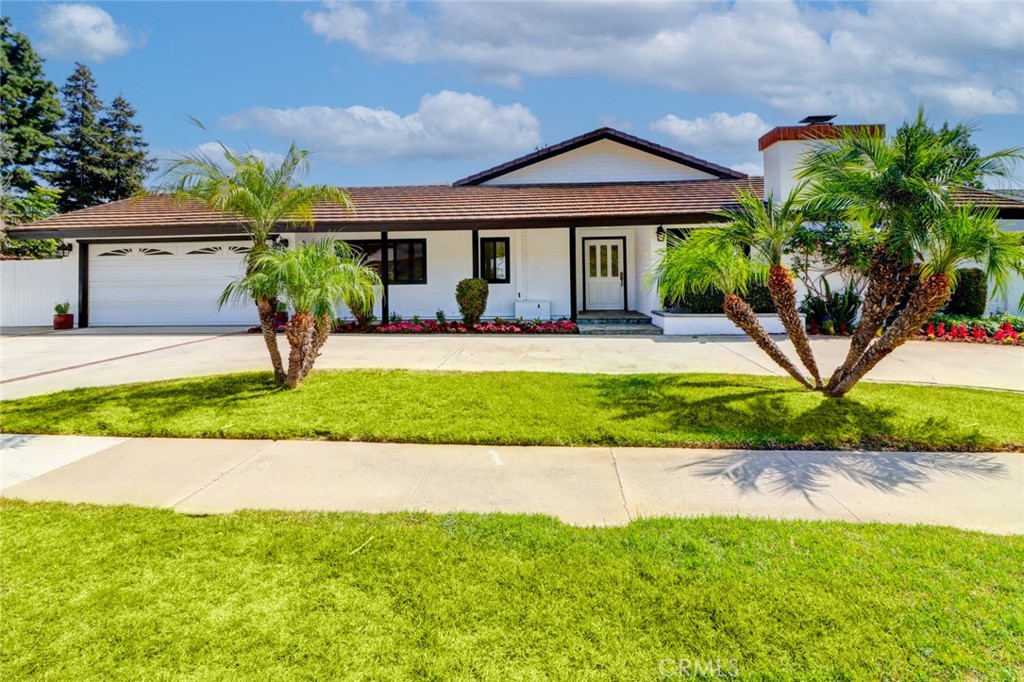 Discover modern luxury in this completely remodeled single-story home. Boasting four large bedrooms and three upscale bathrooms within its 2,773 sq. ft., this residence sits on a generous 9,000 sq. ft. lot on a peaceful, non-HOA street. Inside, an inviting foyer flows into an expansive open-concept living area with soaring ceilings, abundant natural light (enhanced by Suna light), elegant engineered wood floors, a fireplace, and picturesque backyard views. The chef's dream kitchen features marble accents, a substantial island, premium Thermador appliances (including a smart, Wi-Fi-enabled refrigerator), a six-burner stove, double oven, grill, dishwasher, microwave, wine cellar, and a high-end hood. Enjoy a large pantry, a cozy breakfast nook, and a formal dining area. The spacious master suite offers a walk-in closet and a spa-like bathroom with a separate shower and tub overlooking the pool. Three additional sizable bedrooms include one with a private bath and two sharing a well-appointed bathroom. A large laundry room adds convenience. Step outside to a backyard paradise with a pool and gazebo, ensuring privacy. The property also includes an attached two-car garage, a circular driveway with ample parking, and is conveniently located near excellent schools, shopping, dining, golf, and freeways 5 and 55 in a secure, tranquil neighborhood. This exceptional one-story home offers unparalleled modern living. Schedule your showing today!