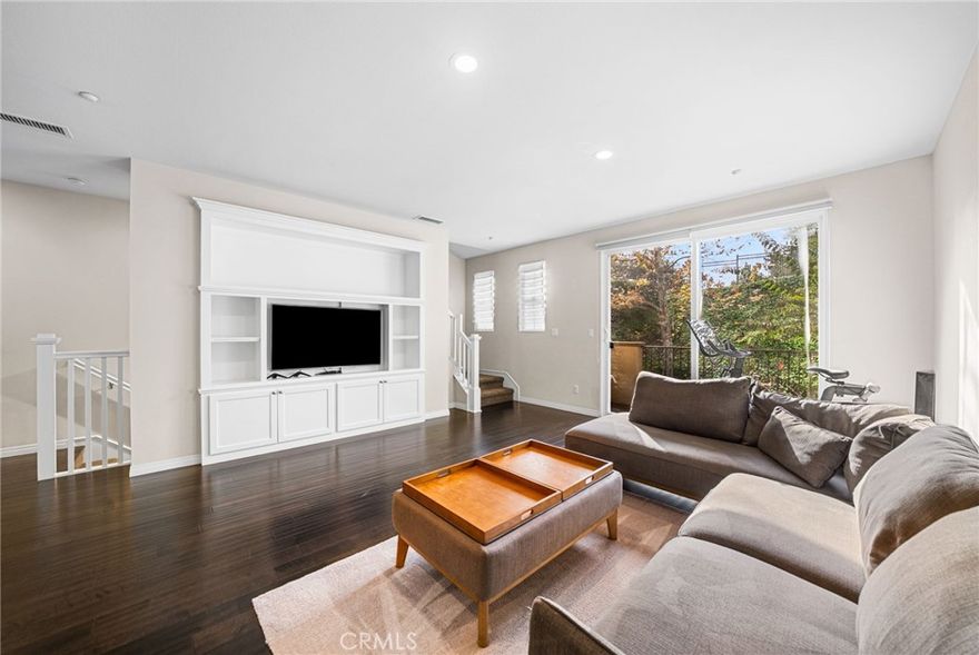 Welcome to this stunning townhome nestled in the highly sought-after Harbor Station neighborhood within the Glenwood community of Aliso Viejo — one of Orange County’s most desirable places to call home! This beautifully upgraded 2-bedroom, 2.5-bathroom residence offers the perfect blend of sophistication, comfort, and modern convenience.
Step inside to find a bright and open floor plan with 1,514 sq. ft. of thoughtfully designed living space, highlighted by high ceilings, recessed lighting, rich hardwood floors, and upgraded finishes throughout. The first level features a welcoming foyer that leads to a private bedroom suite with a full bath and direct access to the attached 2-car garage, now equipped with a 240V outlet for EV charging!
Upstairs, the main living area showcases a seamless flow between the living room, dining area, and gourmet kitchen—perfect for entertaining or simply relaxing at home. Enjoy designer stone countertops, under cabinet lighting, classic shaker-style cabinetry, stainless steel appliances, and an elegant tile backsplash. The living room has beautiful built-ins along with smart Philips Hue recessed lighting for customizable ambiance. The room also opens to a private balcony overlooking lush greenbelts, creating a tranquil space to unwind or sip your morning coffee.
The primary suite on the top floor is a true retreat, featuring scenic treetop views, a spacious walk-in closet, and a spa-inspired bathroom with dual sinks, a soaking tub, and a separate glass-enclosed shower. 
Major system upgrades add lasting value and peace of mind, including a $28,000 SoCal Airflow Pros HVAC system with new AC unit, condenser, and lineset installation, a new water heater, and $3,000 in electrical enhancements—including newly added recessed lighting and modern wiring in the living room.
Enjoy Aliso Viejo’s best lifestyle amenities right outside your door. The Glenwood community is close to multiple pools and a spa, as well as picturesque parks, hiking and biking trails, and family-friendly events year-round. You’re also just minutes from Aliso Viejo Town Center, filled with shopping, dining, and entertainment options, plus easy access to the 73 toll road and nearby beaches.
If you’ve been searching for Aliso Viejo real estate that combines modern upgrades, privacy, and location, this home is a true standout. Schedule your private showing today!