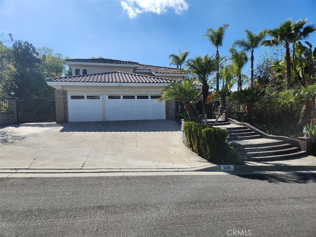 Nestled in the prestigious South Hills community of West Covina, this newly fully renovated home offers unparalleled luxury and comfort. Featuring 4 bedrooms and 3 bathrooms, this residence impresses with its vaulted ceilings and open floor plan, creating a bright and spacious living environment. The first-floor guest room with an adjacent bathroom provides convenience and privacy. Situated on approximately half an acre, the property boasts a 3 car garage, abundance of mature fruit trees, terraced landscaping, and an elevated patio that offers breathtaking views of the San Gabriel Valley. This unique hillside retreat is located in a very safe and quiet neighborhood with no through traffic, making it an ideal sanctuary for families seeking tranquility and elegance.