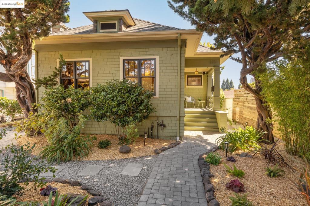 Welcome to this beautifully updated, single-level Craftsman home where timeless charm meets modern comfort. This 3-bedroom, 2-bath retreat offers bright, open spaces, historic architectural details, and a thoughtful layout that makes everyday living feel special. At the heart of the home is a chef’s kitchen with an oversized island topped with stone, a breakfast bar, high-end appliances, built-in desk, and sliding glass doors that disappear into the wall, extending the living space outside onto the deck and gorgeous grounds. The dining room features a box-beam ceiling and bay window, while the inviting living room centers around a tiled fireplace with classic built-ins. The serene primary suite includes a spa-like bath; two additional bedrooms share an updated bath. Outdoors, a tranquil, landscaped backyard features lounge areas, fruit trees and flowering vines, and an outdoor cooking area complete with a Green Egg Kamado Grill— and sets the stage for relaxed weekends and lively gatherings. Ideally located near Berkeley Bowl, Tuesday Farmers’ Market, Rockridge and Elmwood shops, and Ashby BART. This home blends Craftsman character, modern upgrades, indoor-outdoor flow, and a prime location—East Bay living at its best!