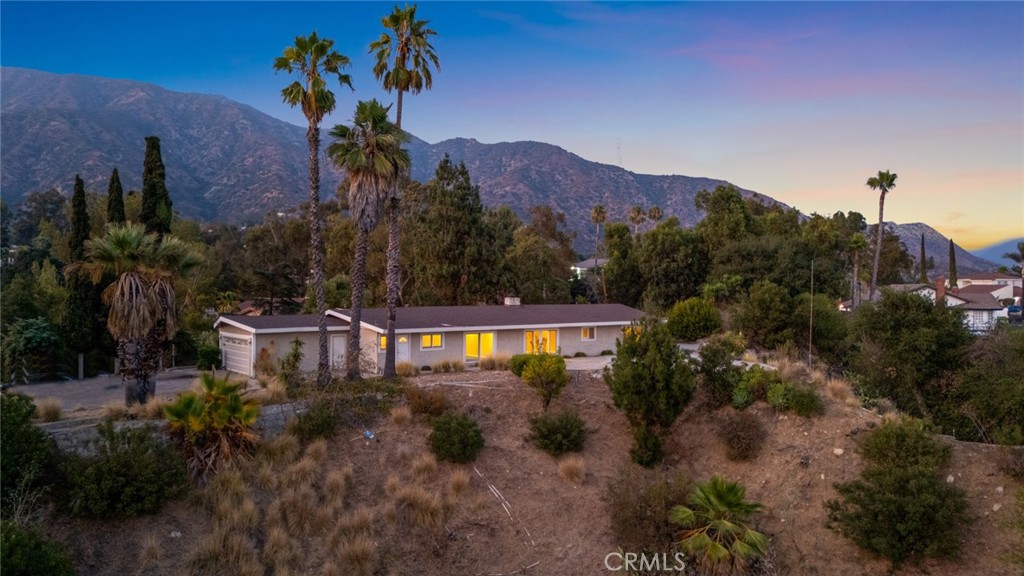 Incredible Views in Bradbury Oaks Estates! Situated in the prestigious gated community of Woodlyn Lane, this top-of-the-hill 2.45-acre property offers a rare combination of privacy, space, and breathtaking scenery—mountain views greet you looking North, while the South view showcases dazzling city lights at night. The single-level, 4-bedroom, 2.5-bath home boasts wood floors, abundant crown molding, fireplace and Anderson windows, ensuring a quiet and comfortable interior.
Zoned for horses, the estate includes upper and lower corrals, and versatile land use options—keep the lower corral for equestrian activities and repurpose the upper area for a guest house or expansion. Mature trees and natural landscaping create a serene, secluded setting, with tree-lined roads enhancing the community’s charm and exclusivity.
While the home offers timeless interior finishes and a generous footprint, it’s ready for updating—presenting a rare opportunity to create a custom estate in one of Southern California’s most sought-after locations.