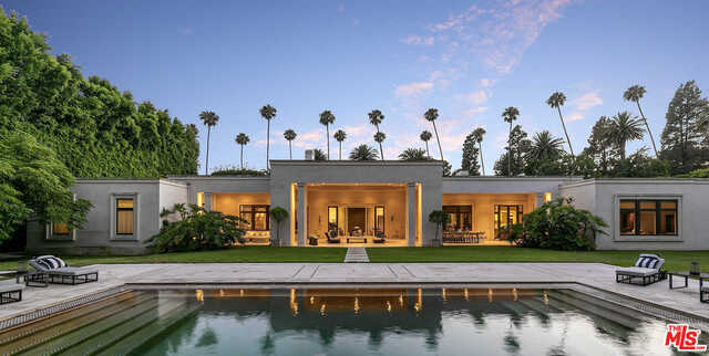 Tucked behind private gates, this Beverly Hills grande dame villa fuses timeless elegance with sophistication, impressive scale and quiet seclusion. The estate's motor court leads to the 4-bedroom, 7-bathroom, single-story residence. Set on a flat, 1-acre lot, the more than 8,000-square-foot home is bordered by manicured hedges and palms. Dark wood double doors reveal a foyer, which spills into an open floor plan with floor-to-ceiling windows and French doors that capture views of the lush grounds and back patio. A large, paneled library/study with fireplace and bar leads into a voluminous chef's kitchen and breakfast area. Additional amenities include a generous media room and 750-bottle wine room. The master suite features dual showroom closets and a bath with a soaking tub. Outside is a skylight-topped loggia made for al fresco dining, plus lawns and a pool. This home epitomizes SoCal's indoor/outdoor lifestyle minutes from the heart of Beverly Hills and West Hollywood.