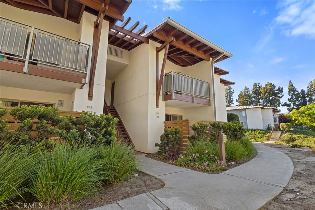 Upstairs Corner Unit in Pacific Pines. Just 3 miles from the beach... This unit is located in a quiet area at the top of the Pacific Pines Racquet Club. This home features luxury vinyl plank flooring, 6-inch baseboards, crown molding, and in-unit laundry for everyday comfort and convenience. The kitchen features granite countertops and ample cabinetry, making it ideal for both cooking and entertaining. Plantation shutters add charm and privacy, and the living area is enhanced by a cozy fireplace with a custom railroad tie mantel. Pacific Pines offers fine community amenities and a truly unique setting nestled beneath soaring Torrey Pines. Ideally located in southwest Encinitas near Cardiff-by-the-Sea, with easy access to shopping, dining, and outdoor recreation.