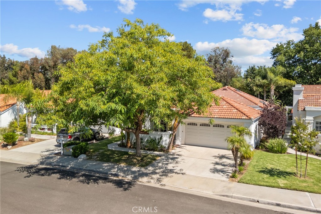 Charming Single-Story Home in the Heart of Valencia Summit
Absolutely beautiful and impeccably maintained, this single-story 3-bedroom, 2-bathroom home offers 1,678 square feet of stylish and comfortable living space in the highly sought-after San Marino tract, nestled within the prestigious Summit community of Valencia. Located on a tranquil cul-de-sac, this home perfectly blends charm, functionality, and convenience.
Inside, you’ll find a thoughtfully designed floor plan featuring two spacious secondary bedrooms and an updated full bath, along with a secluded, oversized primary suite. The primary retreat is a peaceful sanctuary, offering direct access to a private atrium through prism sliding doors, a walk-in closet, built-in linen cabinetry, and an en-suite bathroom complete with a tiled walk-in shower, dual sinks, and a skylight that fills the space with natural light.
The formal step-down living room has been transformed into a cozy home theater, complete with built-in speakers, screen, projector, and amplifiers—perfect for movie nights at home. A dedicated dining area features a built-in wineglass display, and the inviting family room is warmed by a fireplace framed by sunlit windows.
The updated kitchen is a chef’s dream, featuring stainless steel appliances, a farmhouse sink, a 5-burner cooktop, a double oven, crisp white cabinetry, a charming bay window, a breakfast bar, and abundant counter and storage space.
Enjoy seamless indoor-outdoor living with multiple sliding doors leading to the front courtyard, side patio, and lush backyard featuring a lemon, plum, and apricot tree. Both secondary bedrooms offer direct backyard access. Additional highlights include vaulted ceilings, mirrored closet doors, multiple skylights, and a convenient indoor laundry area with extra cabinet space.
The attached two-car garage features epoxy flooring, a workbench, a garage door opener, and extensive built-in cabinetry for extra storage.
As a resident of the Valencia Summit, you’ll enjoy access to four pools, three tennis courts, scenic paseos and walking trails, and a welcoming clubhouse. All of this is just minutes from Granary Square, Whole Foods, Westfield Valencia Town Center, College of the Canyons, CalArts, and a variety of local restaurants and entertainment options.
Don’t miss this rare opportunity to own a stunning home in one of Valencia’s most desirable neighborhoods!