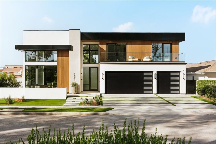 Set within a tranquil equestrian neighborhood overlooking Newport’s Back Bay, The Mesa Estate embodies refined craftsmanship and effortless luxury. Crafted by Burkhart Construction and designed by Grace Blu, this 3,585-square-foot residence offers a seamless blend of sophisticated indoor-outdoor living. Soaring 20-foot+ ceilings and bold architectural lines welcomes you, while expansive windows and La Cantina sliding glass doors seamlessly dissolve the boundary between interior and exterior, flooding the space with natural light. The chef’s kitchen is a masterpiece of style and function, featuring leathered quartzite countertops and professional Wolf appliances, including a six-burner range with an infrared griddle. Designed for both entertaining and relaxation, the private backyard boasts a pool and spa, covered dining, fire pit, outdoor kitchen with BBQ, overhead heaters, and multiple seating areas—perfect for enjoying the coastal climate. The primary suite is a serene retreat, complete with a private balcony, walk-in closet, and spa-like bath finished in elegant Taj Mahal leathered stone. Three bedrooms reside upstairs, while two additional bedrooms, an office, powder room, and two full baths on the main floor provide flexible living options. Additional features include a laundry room, home gym, Savant smart home system, wine fridge, and a three-car garage with ample driveway parking. Just minutes from the beach, Back Bay trails, Fashion Island, and top rated schools, The Mesa Estate offers an unparalleled blend of modern design and relaxed coastal living.