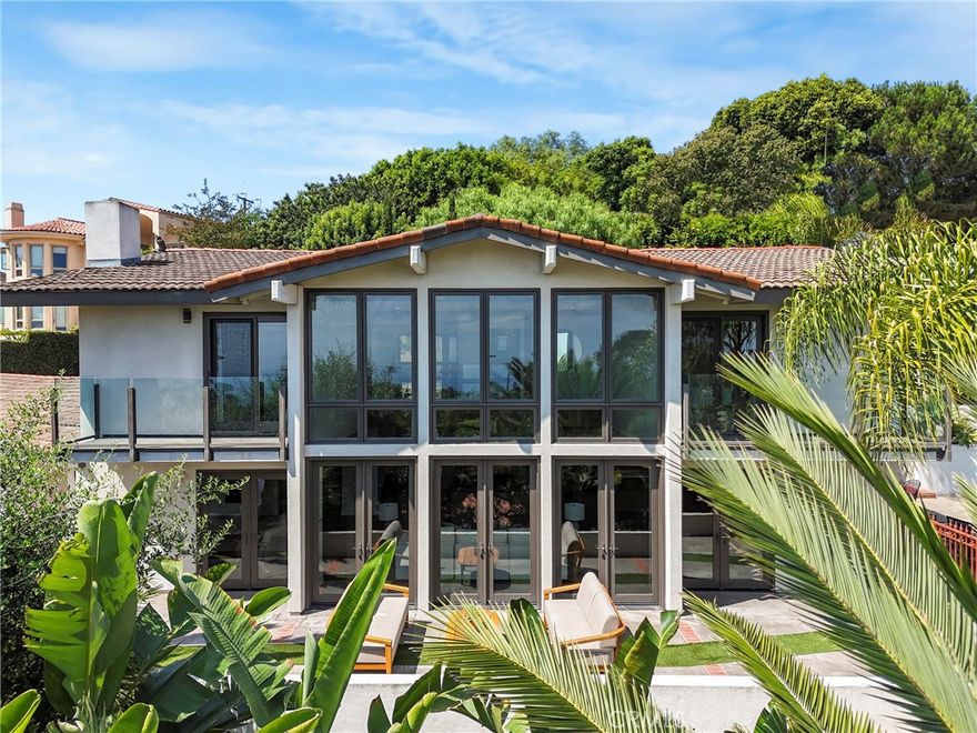 Beautiful and Stunning Custom Contemporary Ocean View home located on top of a private drive well above the street. This three bedroom, three bath with an additional first floor office that doubles as a fourth bedroom artist's home features authentic wood floors, vaulted ceilings, a spectacular open floorplan, glass second floor cat-walk, a modern solid wood kitchen with professional stainless steel Viking Pro appliances, quartz counters, double sinks, a separate utility room, a three car garage with EV NEMA 14-50 charging, central A/C, all on a usable 20,576 square ft. lot. This home was meticulously remodeled to the finest standards to create a completely usable home and yard that flow seamlessly. The great room wall of glass opens to the handsome oversized pool and fountain spillway spa, a large patio for entertaining and private terraced Lombardy deck surrounded by mature junipers. The three additional ocean and harbor view bedrooms are upstairs, The huge primary walk-in closet is almost as large as the primary bedroom itself, tons of natural light and two with their own Verona balconies with glass railings. On a clear day you can see all the way past Newport Beach. The third car garage stall is currently set up as a home gym with zone A/C and heat. It can easily be converted back. This home has designer touch overload. Don't miss out on this unbelievable difficult to find Palos Verdes, Spanish contemporary masterpiece.