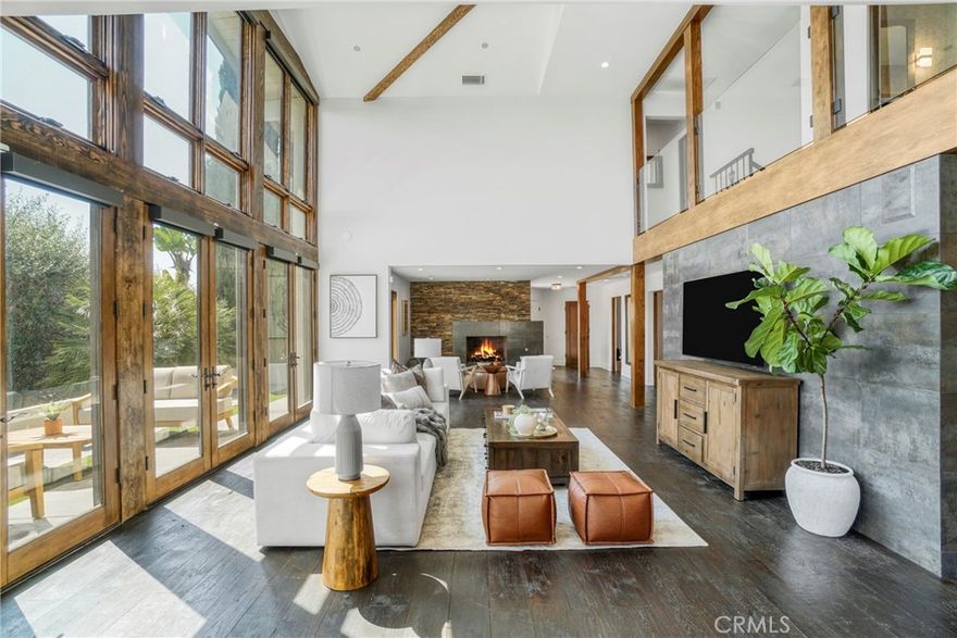 Beautiful and Stunning Custom Contemporary Ocean View home located on top of a private drive well above the street. This three bedroom, three bath with an additional first floor office that doubles as a fourth bedroom artist's home features authentic wood floors, vaulted ceilings, a spectacular open floorplan, glass second floor cat-walk, a modern solid wood kitchen with professional stainless steel Viking Pro appliances, quartz counters, double sinks, a separate utility room, a three car garage with EV NEMA 14-50 charging, central A/C, all on a usable 20,576 square ft. lot. This home was meticulously remodeled to the finest standards to create a completely usable home and yard that flow seamlessly. The great room wall of glass opens to the handsome oversized pool and fountain spillway spa, a large patio for entertaining and private terraced Lombardy deck surrounded by mature junipers. The three additional ocean and harbor view bedrooms are upstairs, The huge primary walk-in closet is almost as large as the primary bedroom itself, tons of natural light and two with their own Verona balconies with glass railings. On a clear day you can see all the way past Newport Beach. The third car garage stall is currently set up as a home gym with zone A/C and heat. It can easily be converted back. This home has designer touch overload. Don't miss out on this unbelievable difficult to find Palos Verdes, Spanish contemporary masterpiece.