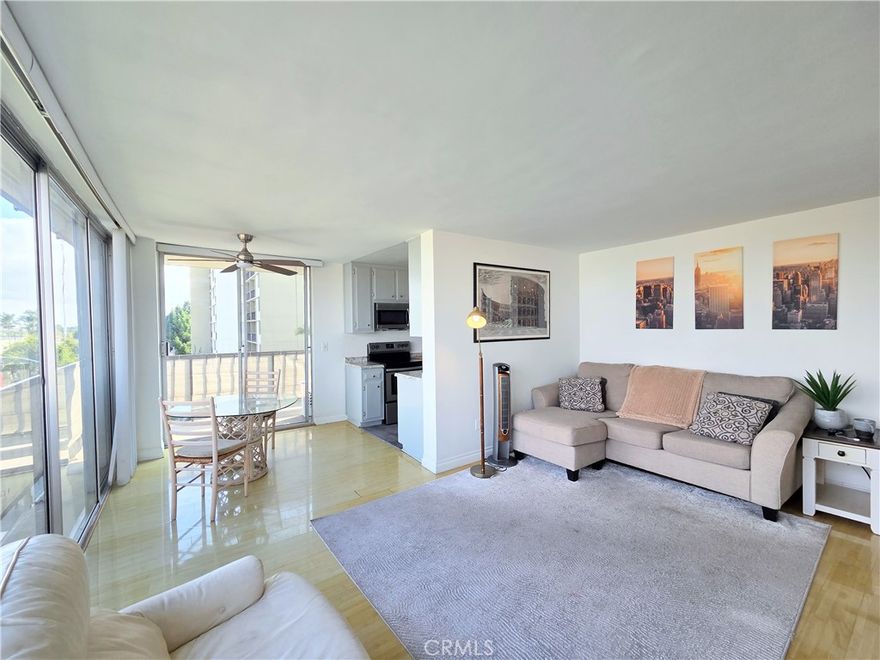 Experience classic mid-century style and incredible views from this top-floor corner unit at The Pacific Royale, a gated condominium community known for its timeless architecture and peaceful atmosphere.

Step through the formal entry into a spacious living room featuring floor-to-ceiling, wall-to-wall glass with sweeping views of the San Gabriel Mountains. Large sliding glass doors open to a wrap-around balcony , perfect for morning coffee or relaxing at sunset.

The open layout connects the living and dining areas to a sleek, modern kitchen finished in a contemporary color scheme and equipped with a full suite of appliances, including a stove, microwave, dishwasher, and refrigerator.

The primary bedroom suite includes an ensuite bathroom, mirrored wardrobe doors, built-in cabinetry for extra storage, and balcony access with city views. The guest bedroom also features full-height windows and a large closet.

Additional highlights include bamboo flooring throughout, a hallway bath, gated and covered parking with overhead storage, and convenient laundry facilities on every floor. Most utilities are included , tenant only pays for electricity.

Enjoy style, comfort, and breathtaking views in one of the area’s most sought-after mid-century communities.