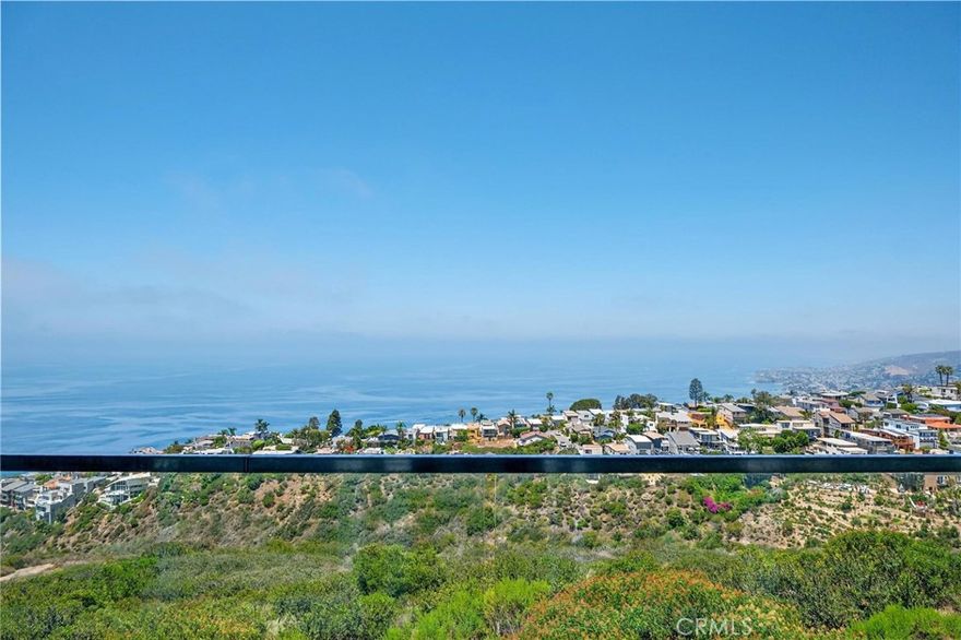 Set in the hills of Arch Beach Heights, this one-of-a-kind multi-level Laguna Beach home offers sweeping panoramic views of the ocean, Catalina Island, coastline, and sparkling city lights from every level. Beautifully remodeled and move-in ready, this rare gem is perfectly positioned on an oversized 1.5-lot parcel, delivering the ideal blend of coastal luxury and laid-back charm. The main level welcomes you with an open-concept floor plan designed for seamless entertaining. A spacious living room and dining area flow effortlessly to a large ocean-facing balcony through expansive glass doors, creating a true indoor-outdoor experience. The designer kitchen is fitted with custom cabinetry, high-end quartz countertops, and premium appliances—crafted to satisfy both form and function. Upstairs, the primary suite offers a peaceful retreat complete with a private ocean-view balcony, a remodeled spa-style bathroom, a walk-in closet, and a second custom wardrobe for added space. Thoughtful upgrades throughout the home include engineered hardwood flooring, custom doors, recessed lighting, energy-efficient windows, and a new heating system with WiFi-enabled controls. Travertine marble lines the staircases and hallway, adding a touch of timeless elegance. The lower level features a private guest suite with its own entrance, bedroom, walk-in closet, and full bath—ideal for visiting family or potential rental income. The exterior is finished with smooth stucco, modern motion-sensor lighting, and tasteful landscaping that enhances both privacy and curb appeal. Just minutes from iconic beaches, scenic hiking trails, upscale dining, art galleries, and world-renowned resorts, this turnkey property captures the essence of Laguna Beach living—offered at a price that’s sure to generate serious interest.