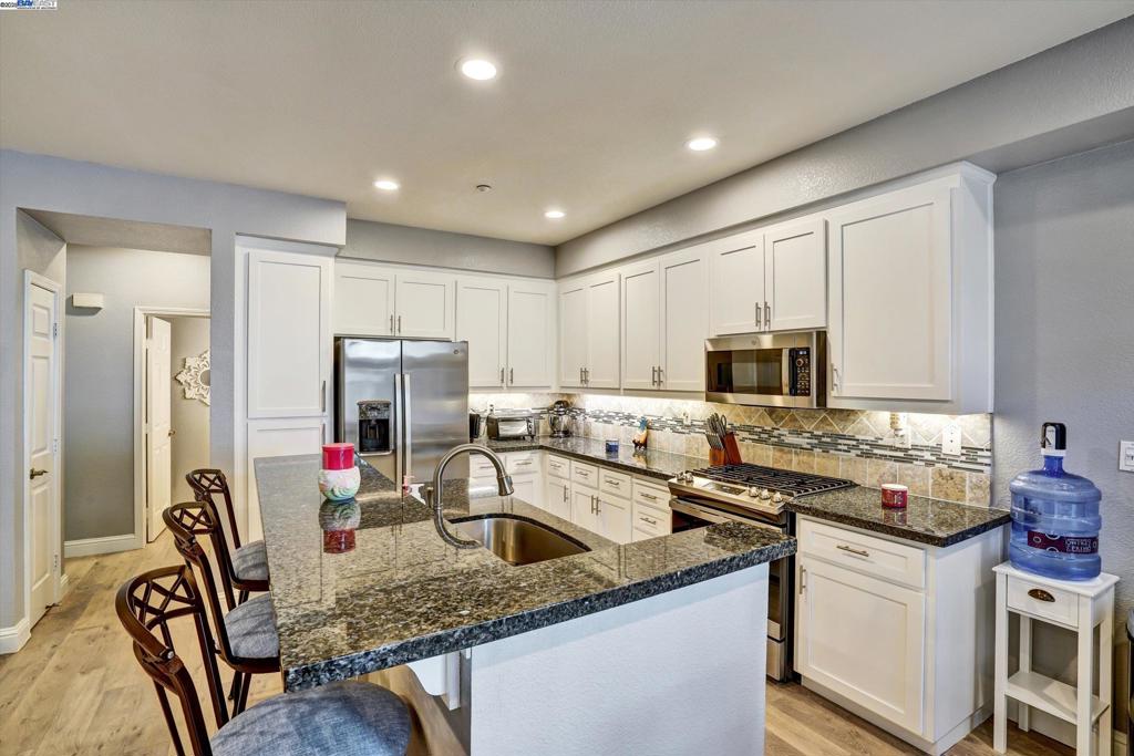 AMAZING NEW PRICE Step into modern elegance in this updated 2 bedroom, 2 ensuite and a half bath downstairs condo. Boasting 1213 sq ft of open concept living space nestled in the secure gated community of Copper Hill. With pool, spa, playground and tennis courts! Newer carpeting upstairs, new laminate flooring downstairs, a beautiful remodeled kitchen, new appliances, granite counter tops, shaker cabinets and a center island. New paint, LED lighting, in ceiling speakers, extra canned lighting, and a beautiful gas fireplace. Garage has a level 2 EV outlet. Located minutes from restaurants , shopping, 580 freeway, the local downtown and the farmers market. It's everything you need for comfortable, convenient living. Whether you are a first time buyer, downsizing or seeking tranquil living, this is the home for you. Come take a peek and see for yourself.