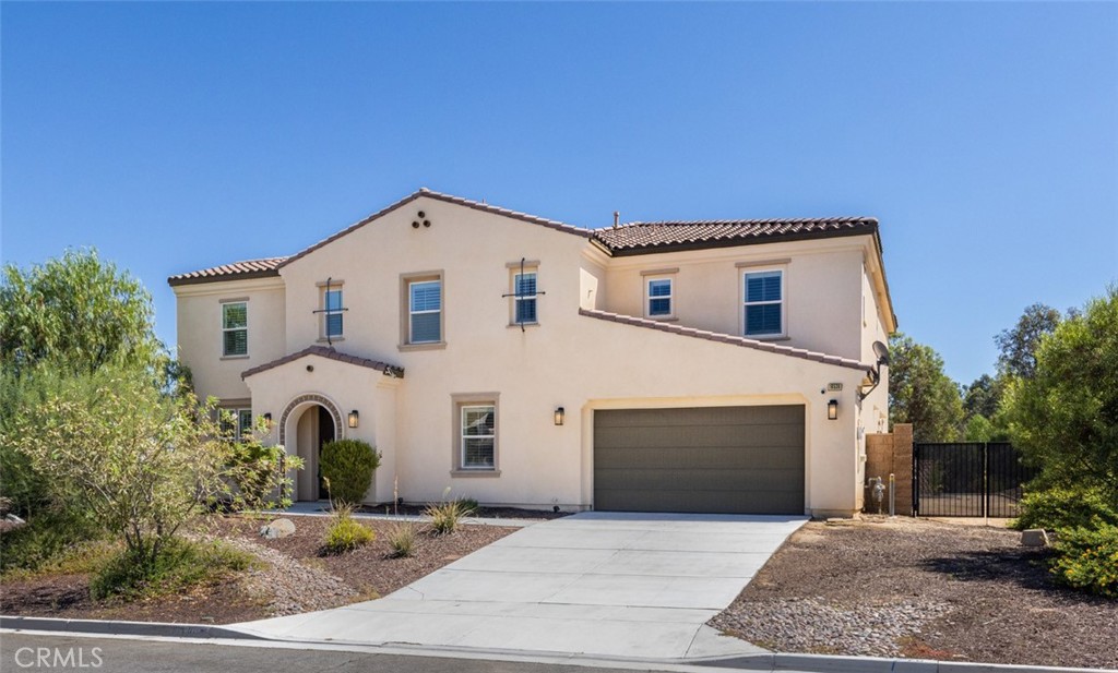 Welcome to 16536 Amberley Court, a stunning 5-bedroom, 4.5-bathroom home offering 4,469 square feet of modern luxury on a sprawling 0.47-acre lot in the hills of Riverside. Built in 2019 and nestled on a quiet cul-de-sac, this exceptional residence showcases breathtaking panoramic views of surrounding mountains, valleys, and hillsides. The thoughtful floor plan includes a formal entry, elegant dining room, and a main-level bedroom with dual walk-in closets and an en-suite bath, plus a guest powder room. The expansive great room impresses with soaring ceilings, walls of windows, and a striking floor-to-ceiling fireplace, while folding glass doors open to a wraparound backyard—an entertainer’s dream with space for a custom pool and spa. The gourmet kitchen features stainless steel appliances including dual ovens, microwave, dishwasher, range, and refrigerator, along with a walk-in pantry and abundant cabinetry. Upstairs, a versatile loft complements three spacious bedrooms and the luxurious primary suite, complete with dual walk-in closets and a spa-inspired bath with soaking tub, oversized dual shower, dual vanities, and a separate makeup vanity. Another upstairs bedroom enjoys its own en-suite bath and walk-in closet, and the full laundry room—with washer and dryer included—adds everyday ease. Additional highlights include a four-car garage, dual AC units, tankless water heater, laminate flooring downstairs, plush carpet upstairs, drip irrigation system, fully paid solar, and no HOA. Combining contemporary elegance with comfort and functionality, this home offers an elevated lifestyle with unmatched views in one of Riverside’s most desirable communities.