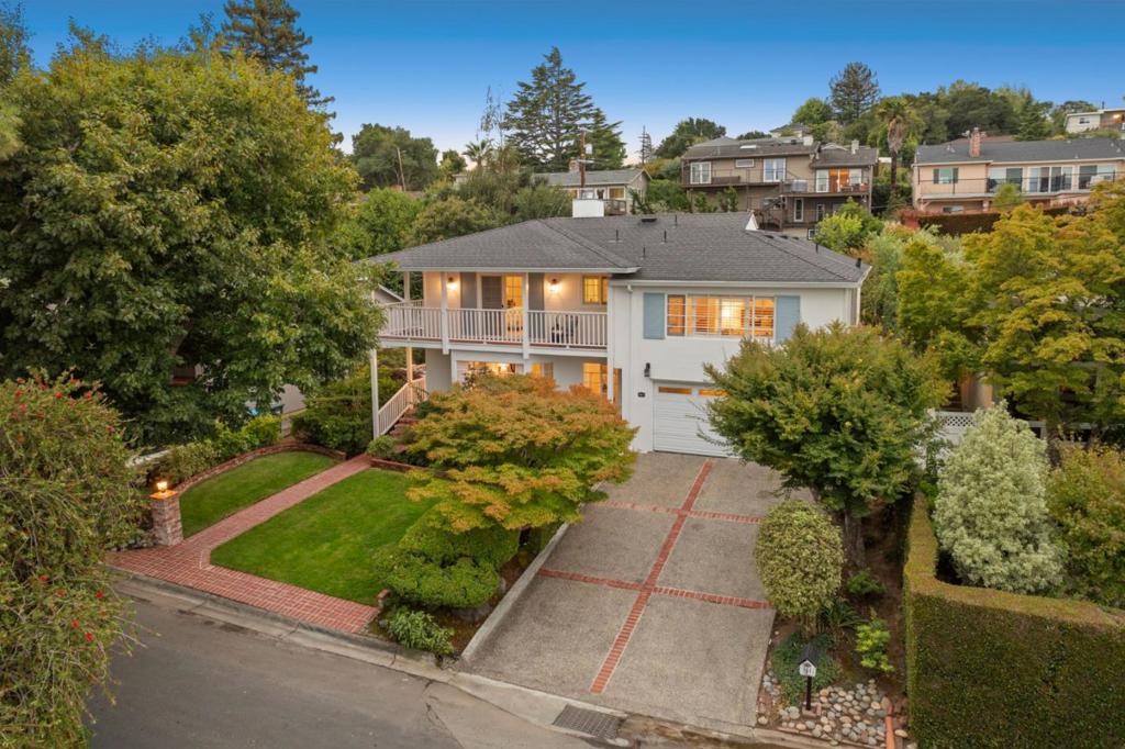 Fresh updates and classic traditional style define this Burlingame Hills home with a nod to Monterey Colonial design and a sparkling pool in the private rear yard. The two-story floor plan has 5 bedrooms and 3 baths, including one bedroom on the main level customized for an office plus an upstairs primary suite that opens to the wraparound covered front porch. Formal living and dining room combination has newly refinished hardwood floors and a fireplace, while the kitchen and family room welcome everyday living with large breakfast area and sliding glass doors to the rear yard and pool. Wood-paneled coffered ceilings, abundant built-in cabinetry, updated baths, and new carpet enhance the interiors. Located on a non-through street with direct access to hiking trails at Mills Canyon Park, this home also benefits from access to top-rated Burlingame schools and proximity to both San Francisco and Silicon Valley.