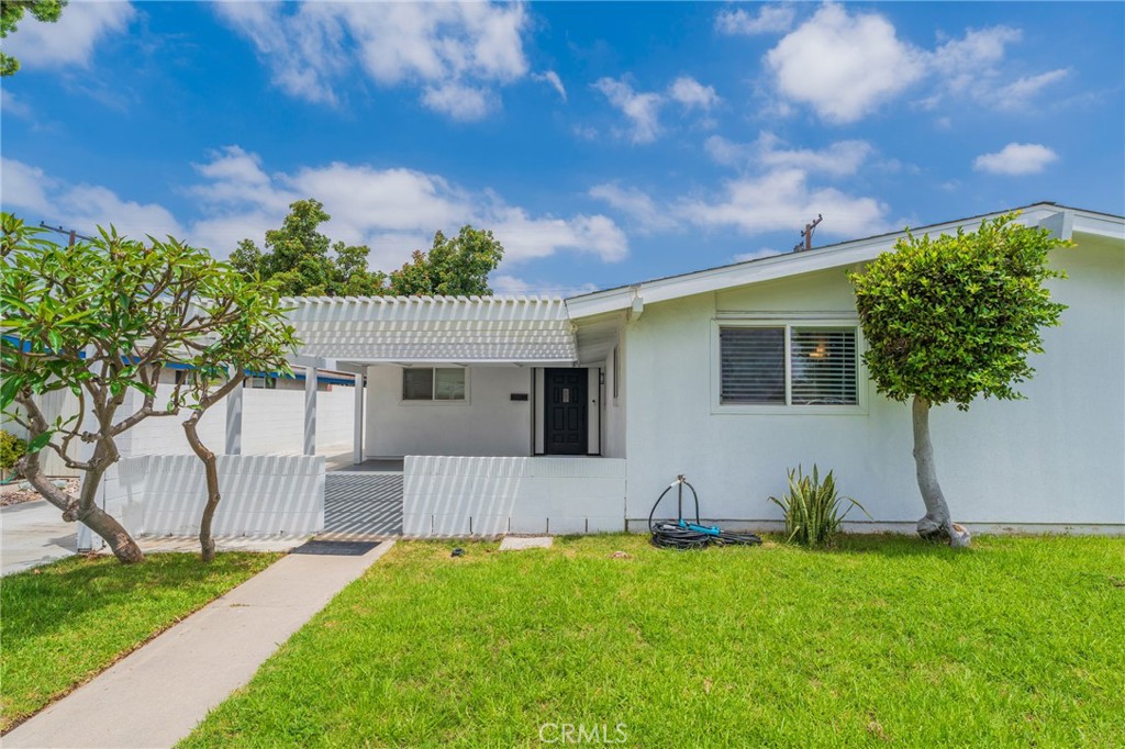 Discover your Mid-Century Marvel at 1925 West Beacon Avenue in Anaheim! Offered at $949,900, this stunning 4-bedroom, 2-bathroom home spans 1,375 sq ft on a spacious 6,100 sq ft lot in a pride-of-ownership West Anaheim neighborhood. Built in 1955, this residence seamlessly blends classic charm with modern upgrades, allowing you to move right in! Enjoy an incredible covered patio entryway and a long driveway providing ample parking. Inside, you'll find an open floor plan with vaulted beam ceilings and abundant natural light from multiple dual-pane windows. The heart of the home, a crisp white kitchen, has been recently remodeled with solid surface counters, a full backsplash, and high-end appliances (included!). Both bathrooms are elegantly remodeled, including a primary private bath with tub to relax in and hall bath with a step-in shower. Features also include newer paint, fresh flooring, recessed lighting, and convenient indoor washer/dryer hookups. A floor-to-ceiling elegant fireplace adds warmth and character. This ideal location is next to parks, shopping, and offers easy freeway access, making it the perfect blend of style, comfort, and convenience.