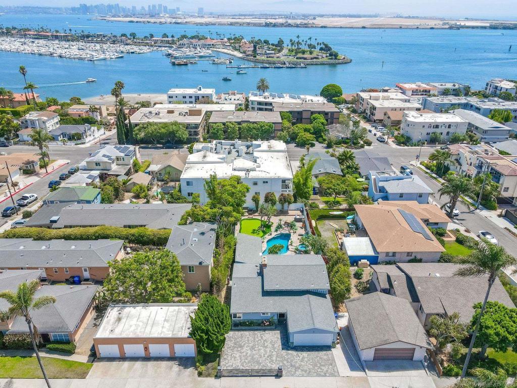 Stunning La Playa Coastal Retreat with Ocean Views! Experience luxury coastal living in this fully renovated 2024 Point Loma masterpiece, ideally situated in the coveted La Playa neighborhood. Just a short stroll to the beach, this modern home blends timeless elegance with resort-style amenities. The main residence offers 4 spacious bedrooms and 3.5 baths, including two primary suites with spa-like bathrooms. A detached guest house provides flexibility for visitors, multi-generational living, or a private office. The modern open-concept design features sleek finishes, expansive windows, and seamless indoor-outdoor flow. Step outside to your private paradise: a brand-new saltwater heated pool and spa, a putting green, and a game room for year-round entertainment. The upper balcony captures panoramic views of the backyard oasis, the harbor, and the Pacific Ocean beyond. No HOA and no Mello Roos. Walking distance to the beach, yacht club, restaurants, and shops. Just minutes to downtown San Diego