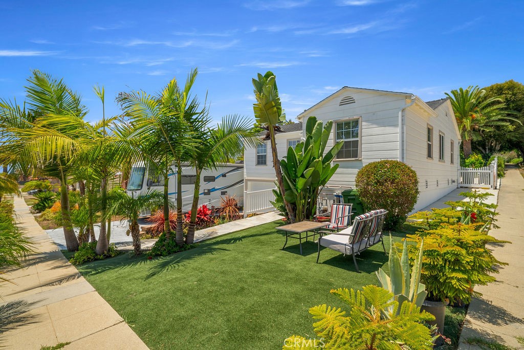 Nestled just a block away from the ocean in the coveted Palisades neighborhood of San Pedro, this beautifully remodeled home is a sanctuary of comfort and style. Boasting 4 spacious bedrooms and 3 elegant bathrooms, this residence offers an open floor plan bathed in natural light, making every corner of its 2,377 square feet feel bright and welcoming. The heart of the home is the eat-in kitchen, featuring a generous island with abundant cabinet space, ideal for culinary enthusiasts. Enjoy ocean views from the large primary suite or unwind in the newly added sauna. The home is equipped with a 220 AMP electric panel and Central AC to ensure modern conveniences are at your fingertips. Whether you're entertaining in the backyard, practicing your swing on the putting green, or relaxing in the spa, the outdoor spaces redefine luxury living. With a newer roof, double pane windows, and enlarged 2-car garage, plus RV parking, every detail has been thoughtfully considered. Downstairs, you'll find a 494 square foot Junior ADU with a private entrance and separate house number. This versatile space includes a kitchenette and laundry hookups and bathroom, perfect for guests or as a rental opportunity. Located just steps from the ocean, this home offers a unique blend of tranquility and convenience, making it a perfect retreat. Don’t miss the chance to make this ocean-view gem your own!