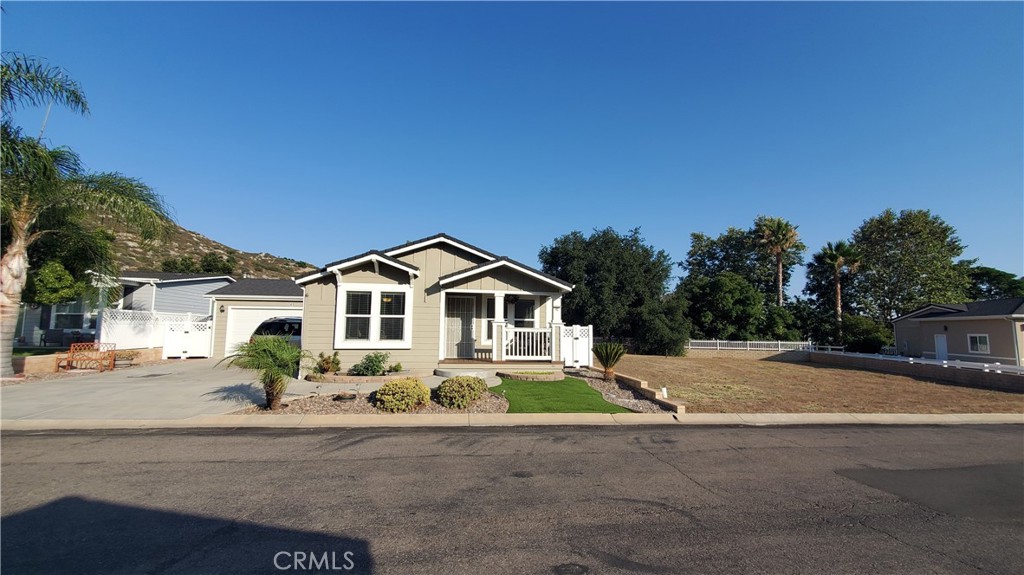 Great location within Oak Tree Ranch, next to a vacant lot & backing to the seasonal creek creates a uniquely private homesite! Beautiful open floor plan! This 2018 manufactured home features 3 bedrooms, 2 baths,1420 sqft with attached 2 car garage and professionally landscaped and fenced back yard! Located close to the community pool ,club house, mail boxes and guest parking! Enter directly into the living room with Kitchen and dining room creating a spacious open floorplan! Transom windows let in an abundance of natural light and combined with the high ceilings create a light, bright and spacious interior. The garage has direct access to the house through the laundry room. Luxury wood plank vinyl flooring throughout with carpet in the bedrooms. Ceiling fans in all bedrooms! Guest bath has a tub shower combo and tiled backsplash on the single sink vanity. Master bath has a large, beautiful step in shower with glass doors and separate toilet room, cabinets for linen and a vanity with storage. The Kitchen features recessed lighting , gas cooktop and oven, dish washer, microwave , stainless steel double sink. Large island with breakfast bar and contemporary pendant lighting fixtures. Oak Tree Ranch is a beautiful, all age community with community pool, bbq area, car washing station, dog park, picnic area, play ground, stage for special events, lovely remodeled club house with library and full kitchen. Manicured lawns and beautiful park like setting welcome you home! There are areas for visitor parking for family and friends. Come and enjoy the lifestyle you've been looking for!