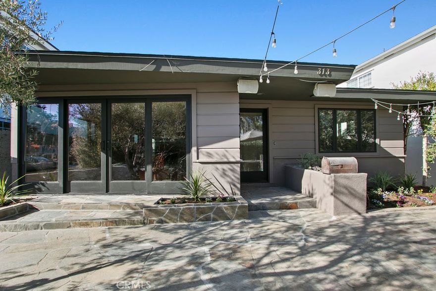 In the heart of Corona del Mar’s Village, south of PCH, this single-level coastal residence offers the perfect blend of charm, comfort, and convenience. Featuring 3 bedrooms and 2 baths, the home sits on an impressive 40-foot-wide lot along one of the Flower Streets’ most desirable blocks, providing rare width, light, and outdoor living space. Inside, a bright and inviting living area welcomes you with abundant natural light and a cozy fireplace. The newly remodeled kitchen has been thoughtfully upgraded with a Viking range, quartz countertops, and crisp cabinetry, ideal for both everyday cooking and elevated entertaining. The kitchen flows seamlessly into the dining area and out to the home’s outdoor spaces. Both bathrooms have also been newly remodeled with fresh, modern finishes that elevate the home’s comfort and style. Additional recent upgrades, including a new roof and new windows, enhance the home’s efficiency, durability, and overall appeal. Three well-proportioned bedrooms offer flexibility for guests, a home office, or family living, all conveniently on one level. Outdoor living is a hallmark of this property. A large front patio captures the true CDM lifestyle with room to relax and enjoy the neighborhood ambiance, while the private back deck provides the perfect setting for dining, lounging, and entertaining. With an attached garage and an easy, walkable location just steps from local cafés, boutique shops, restaurants, parks, and world-class beaches, 313 Larkspur embodies the best of Village living—relaxed, coastal, and effortlessly enjoyable.