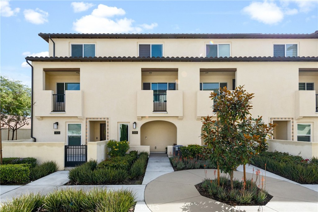 Priced to sell, nearly brand-new home with no mello-roos! Move-in ready unit located in the gated community of Jasmine Walk in Buena Park. Built in 2022, this newer home has been beautifully upgraded with modern luxury vinyl plank flooring throughout. In the Great Room on the second level you are greeted by a stylish kitchen and oversized kitchen island. The kitchen boasts sleek quartz countertops, elegant tile backsplash, ample cabinet space, recessed lighting, and stainless steel appliances. Also found on the second level is a conveniently located bedroom, full restroom, a bright living room, and covered balcony space. On the upper level you'll find a dedicated laundry room, your large primary suite and a secondary bedroom with a private en-suite bath. Downstairs you will find a spacious direct access tandem garage with a dedicated water softener system. This centrally located Orange County home provides unparalleled access to every major freeway in the area without being directly next to a busy freeway. Just a short cruise down Beach Blvd you will find The Source, shopping, restaurants, and nightlife. Come seize this unique opportunity while it lasts!