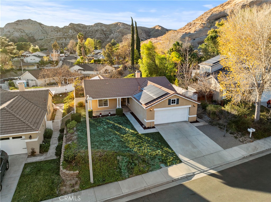 Come see one the best VIEWS in Santa Clarita! Welcome to 30431 Sunrose, nestled in the peaceful cul de sac surrounded with mountain and hillside views. I guarantee you will fall in love with your sunsets. Plus, enjoy your neighborhood privacy living in the desired quiet Californian Canyons community. This beautiful single-story home is perfect for your family with 3 bedrooms, 2 full bathrooms and plenty of space. As you walk up to the house, you will find the covered front porch perfect for a swing chair while enjoying your morning coffee. Inside is light bright high ceilings with kitchen recess lighting, luxury vinyl wood flooring throughout the adjacent dining and living room. You’ll see a natural flow of the home from the entrance to the back French doors leading your backyard patio. The large painted kitchen features granite counters with lots of space, stainless steel appliances, refrigerator, with a cute window that offers more natural lighting providing access to your 2-car garage with direct access-easy for grocery days. Next to the kitchen is the family room showcasing a cozy gas fireplace to enjoy in the evening and cold days. On the left side of the house you will see a full bathroom, bedrooms 1, 2 and 3 are adjacent to, the hallway has plenty of storage. The spacious primary bedroom offers natural lighting, a double closet with his and hers sinks. 2 freshly painted rooms. French doors that give you access to the backyard has a patio and a spacious yard- perfect for a BBQ and playground for the children. AC and water tank are new from 2020. Enjoy NO electricity bill - with your Sunrun solar lease enjoy fantastic savings. Plus, feel safe with a Tesla battery charger for any power outage, it can keep you powered for up to 3 days. This home is perfectly located uphill and providing lots of privacy. Sunrose is only 5min away from the 14fwy easy access to medical center Facey, nearby is shopping center, Vons, Starbucks and In n Out burger. Nearby schools are Pinetree Elementary, Sierra Vista Jr High and Canyon High school, not too far is also College of the Canyons Canyon Country location. Come see this beautiful home, it won’t last long.