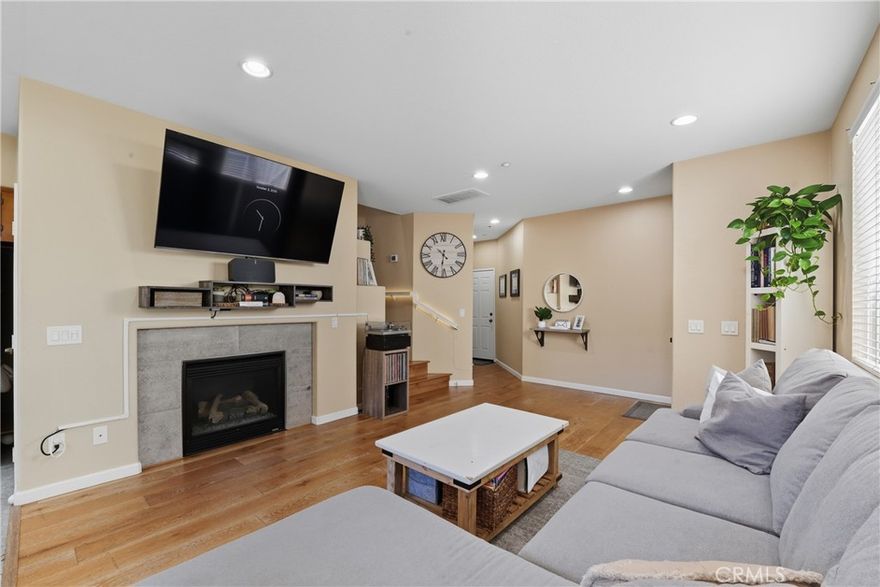 Modern Comfort in a Gated Community in West Murrieta! Welcome to this beautifully updated 2-bedroom, 2 and 1/2  bath condo located in a secure gated community with great amenities including a sparkling pool, relaxing spa, and park areas. Step into the bright, open living room featuring a cozy fireplace, perfect for relaxing nights in. The kitchen boasts beautiful countertops, stainless steel appliances, and a walk-in pantry. This home offers ample rooms with modern finishes, an attached garage for convenience, and a private backyard adorned with string lights, an ideal space for entertaining or unwinding under the stars. Stylish, spacious, and move-in ready this home truly has it all! Walking distance to Old town Murrieta, library, shopping and award winning schools! Don't miss your chance to see it!