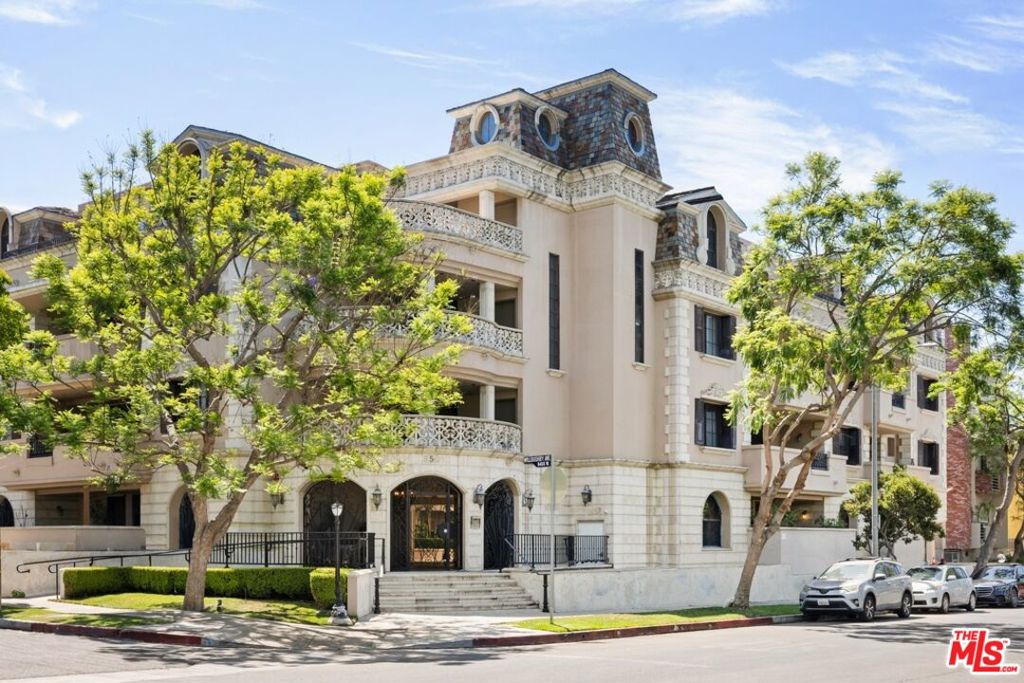 Situated on one of the most coveted streets in the Melrose Place/West Hollywood area, sophisticated luxury condominium offers timeless elegance and modern convenience in a boutique building. Boasting a spacious open floor plan with dramatic archways, curved walls, soaring ceilings, and designer hardwood floors, the home is thoughtfully designed for both entertaining and everyday living. The gourmet kitchen features sleek granite counters and stainless-steel appliances, flowing effortlessly into the oversized balcony, perfect for al fresco dining or evening gatherings. Additional highlights include custom built-ins, an in-unit washer and dryer, two dedicated parking spaces, extra storage, and guest parking. Located steps from world-class dining and shopping on La Cienega, Melrose, and Santa Monica, this condo epitomizes refined urban living in the heart of West Hollywood.