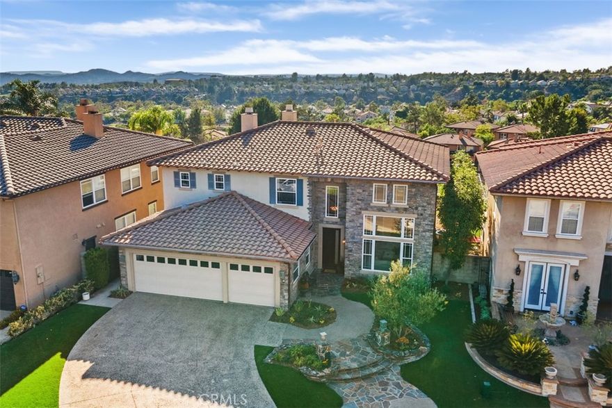 Welcome to 15 Ravensridge, a beautifully upgraded elegant home located in the 24 hours guard-gated community of Dove Canyon. Nestled on a quiet cul-de-sac within the prestigious Laurel’s tract, this home offers timeless elegance, modern upgrades, and incredible views.  4 bedrooms, 3 baths.



Step inside through the newly installed elegant front door and be greeted by soaring ceilings, abundant natural light, and sweeping panoramic sunset views from the formal living room, formal dinning room, family room, and kitchen. The home feels much larger than its indicated square footage, thanks to its open layout and spacious flow. The gourmet kitchen has been recently upgraded with a large extended island with built-in drawer microwave, quartz countertops, and a tasteful designer backsplash. The extended island can server as a breakfast bar or extra prep area. The kitchen seamlessly connects to the expansive family room, where a cozy fireplace serves as the focal point.



The thoughtful floor plan includes a convenient main-level bedroom with a fully upgraded bathroom, currently used as an office with built-ins. Upstairs, the primary suite features its own fireplace, breathtaking panoramic sunset views, and a primary suite. Two additional bedrooms share an upgraded Jack and Jill bathroom, combining comfort with functionality.  The home has been re-piped and recently freshly repainted and recarpeted.



Enjoy year-round outdoor living in the POOL SIZE spacious backyard, complete with a built-in barbecue, a beautiful outdoor fireplace, and plenty of room to entertain and amazing views. Additional highlights include a long driveway accommodating multiple cars, ample spacing between neighboring homes, and an ideal cul-de-sac location.



Dove Canyon residents enjoy exclusive access to outstanding amenities including tennis/pickleball courts, a junior Olympic-sized pool, scenic hiking and biking trails, a children’s playground, and a community sports park. The neighborhood is also home to the private, fee-based Jack Nicklaus Signature Golf Club, offering one of Southern California’s premier golf experiences.



This home is served by the award-winning Saddleback Valley Unified School District and is also close to several highly rated private schools. This is a great opportunity to own a turn-key home with exceptional upgrades, expansive sunset views, and an enviable location in The Laurel’s.