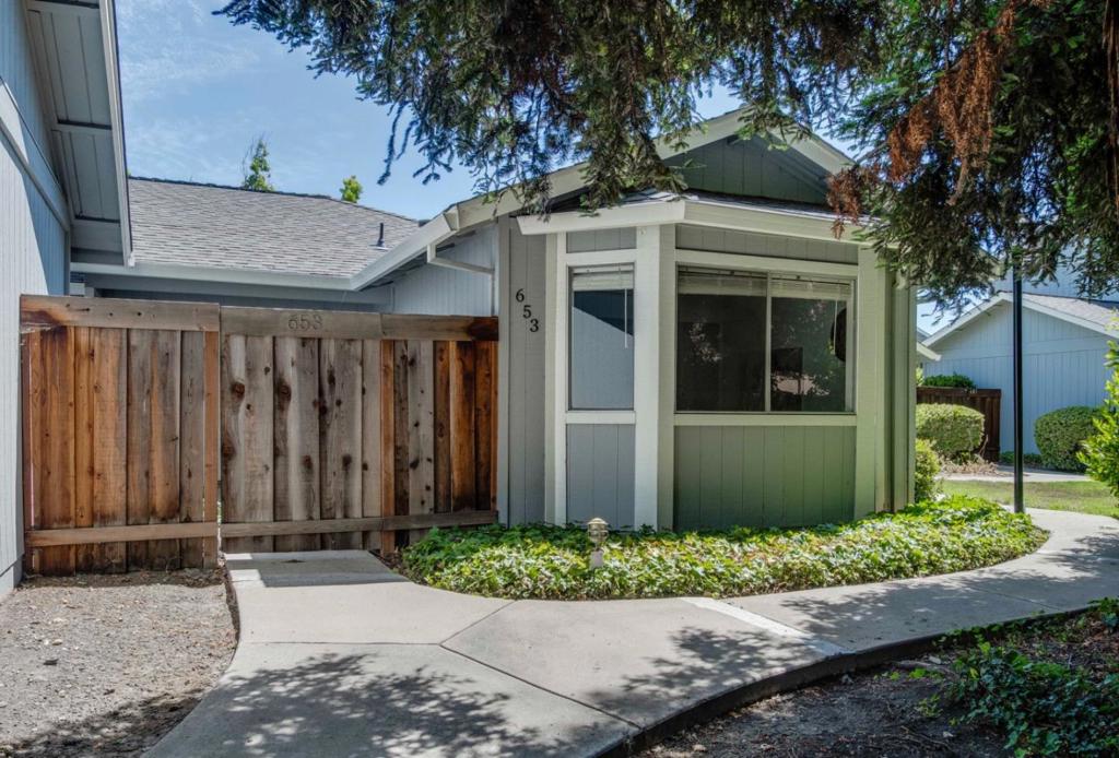 Pack your boxes and move in. This remodeled single level condo has a brand new kitchen complete with white cabinets, black hardware, stylish quartz counter tops, stainless steel appliances, recessed lightings and garden window. Open floor plan with breakfast bar, with combined dining and living area. Beautiful laminated wood-look floors throughout. Two updated bathrooms. Hall bath features shower over tub, new cabinets with stylish quartz counter tops. Primary bath has a double sink white vanity with quartz counter tops. The primary walk-in closet will delight you, and there is a sliding door leading to the private yard. Two side-by-side car attached garage. There is lots of natural lighting. Central heating and central a/c, whole house fans, and ceiling fans. Notice there are no adjoining walls to the living area. So much privacy all on one level. PLUS, community pool ready for your summer enjoyment.