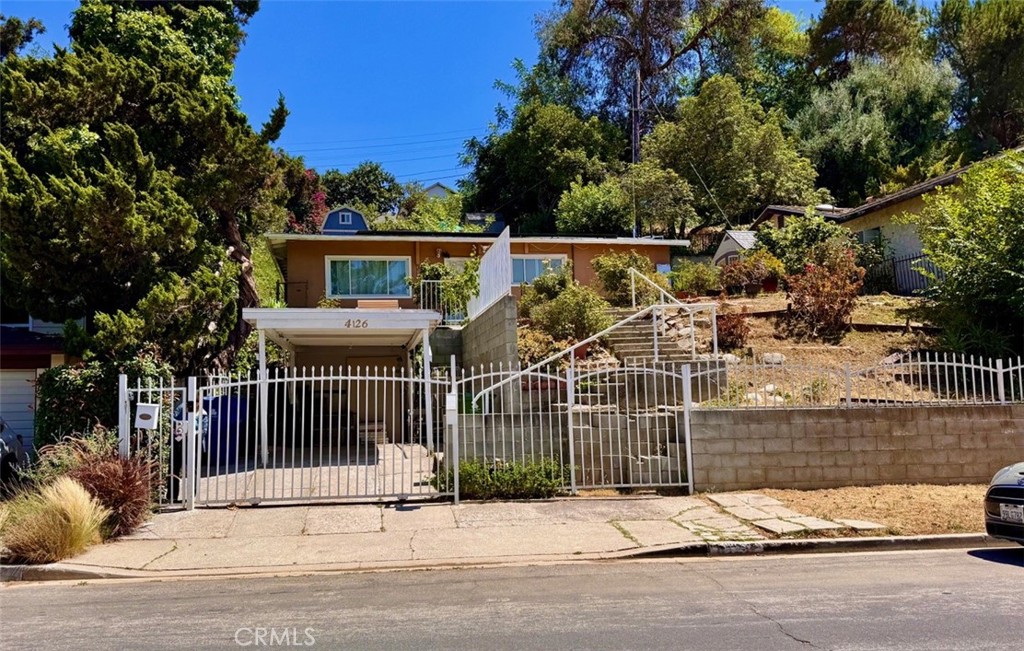 Nestled in the hills of Los Angeles, 4126 Toland Way offers charm, versatility, and sweeping city views. The main house features 2 bedrooms and 2 bathrooms across approximately 900 sq. ft., with an additional 168 sq. ft. interior bonus room perfect for an office, playroom, or creative studio. Perched atop the property is a private granny suite complete with its own kitchenette, bathroom, and shower—ideal for guest accommodations, rental income, or extended family living.
The property also includes four on-site storage units, a 1-car carport, and a Tesla solar system (buyer to assume), adding long-term energy efficiency and value. With its elevated position offering stunning panoramic views of the city, this unique hillside home blends practical living with income potential and privacy. A rare opportunity to own a flexible and well-appointed property in one of L.A.’s desirable eastside neighborhoods.
--