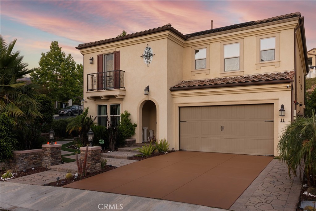 Exuding pride of ownership, this stunning corner-lot home, one of the largest in the neighborhood, offers an open floor plan in the coveted Skyridge community and epitomizes Southern California luxury. With NO Mello-Roos, a 9.1kW paid Tesla solar system, an EV charger in the garage, and a backyard made for entertaining, this residence effortlessly blends style, comfort, and modern convenience. Step into an outdoor entertainer’s paradise featuring a bar and cooking area with BBQ, gas stovetop, refrigerator, and sink with hot and cold water, plus a fire table with wraparound seating. An oversized California Room with motorized shades, gas fireplace, and TV wall extends the living space outdoors, creating the ultimate setting for gatherings year-round. Inside, a soaring two-story foyer with a striking chandelier introduces the home’s designer finishes and open-concept layout. The chef’s kitchen showcases a large island, ceiling-high shaker cabinets, double convection ovens, stainless steel appliances, and a walk-in pantry. The living room, pre-wired for surround sound, flows seamlessly into the formal dining area, while a main floor guest suite with full bath adds versatility and comfort. Upstairs, the primary suite is a private retreat with a balcony featuring motorized shades, spa-inspired bath, and a generous walk-in closet. A flexible loft and laundry room with sink and built-ins complete the upper level. Additional highlights include a garage with epoxy floors, overhead storage, and EV charger, plus a whole-house water softener. Perfectly positioned near the community pool and just minutes from Whiting Ranch, scenic hiking and biking trails, Lake Forest Sports Park, and the 241 and 133 toll roads, this home offers an unmatched blend of luxury, lifestyle, and convenience-truly a once-in-a-lifetime opportunity in one of the area’s most coveted neighborhoods.