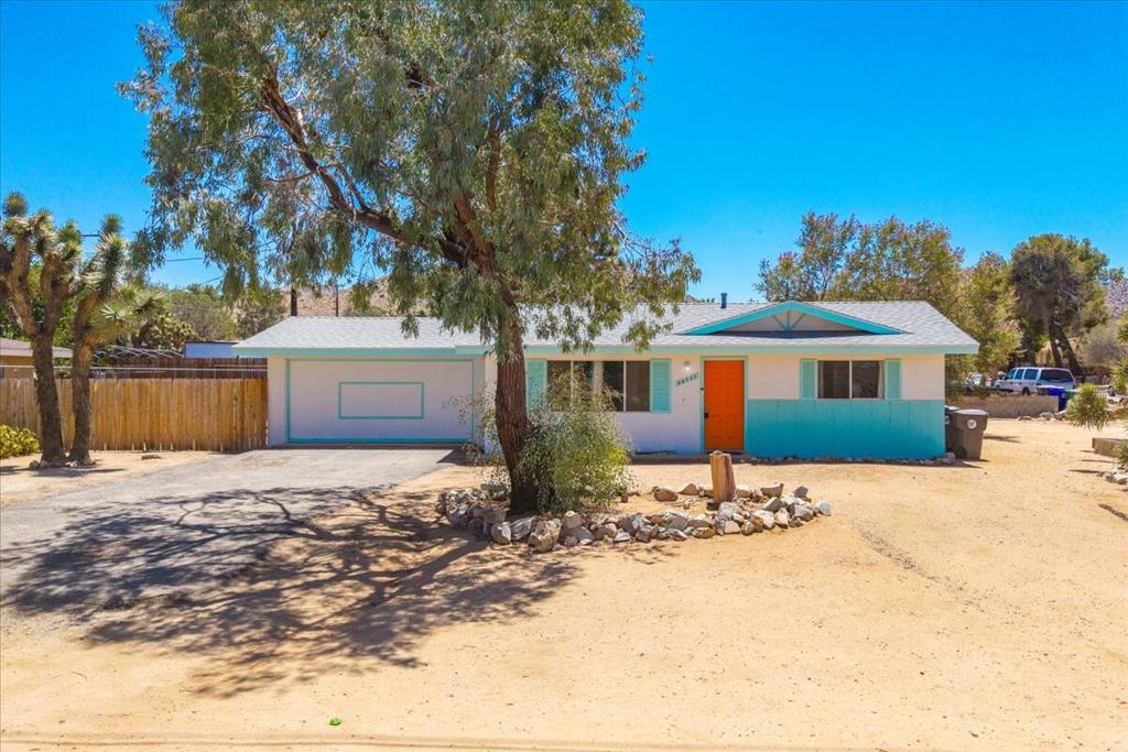 Terrific home on a large corner lot, in a great neighborhood with new and modern features as well as vintage charm, close to shops and restaurants. Up the street from Jacob's Park and nearby Yucca Valley schools. The solar panels on the roof are OWNED, not leased - with a low monthly payment you will own them outright! Each room has its own mini-split heating & cooling system for the most comfort and efficiency. The garage was converted into a large primary bedroom as well as an insulated, wood-paneled flex space, which can be used as an office or for extra storage. There is great separation between the primary bedroom and two guest bedrooms, and all share a single bathroom with vintage tub, toilet and sink! The kitchen is open to the dining area and also boasts a great vintage oven and gas cook top. French doors from the dining area open to the spacious covered patio - great for entertaining or enjoying an al fresco meal. Outside, you have beautiful, mature Joshua trees in both the front and rear yard. The rear yard is fully fenced for privacy and security and there is a new large shed that can be used for storage, hobbies or a workshop. You can live in the home as it is, or with a little sweat equity upgrade the kitchen and bath to add more value to the home. This home has tremendous value and potential! Make an appointment to see it today!