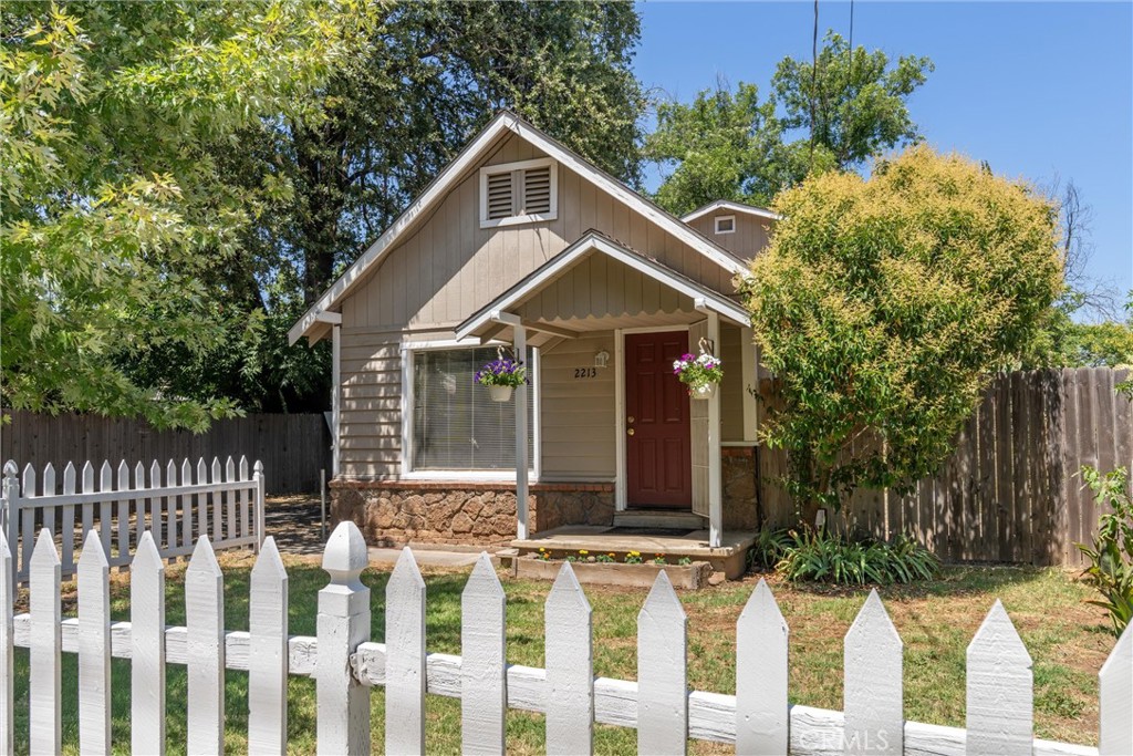 This classic Chico home blends vintage charm with modern versatility. The main house features 2 bedrooms, 1 bathroom, a kitchen with ample storage space, an indoor laundry area, and an abundance of natural light throughout. Both the front and back yards provide great spaces for gardening, relaxing, or entertaining. Additional features include two storage sheds, a covered patio area, and a generous driveway with plenty of off-street parking. Adding to the versatility of the property is a detached garage with an upper-level bonus room above the back patio, accessible via a private stairway. Complete with its own entrance, bathroom, and kitchen area, this space offers endless possibilities. Conveniently located near Highway 99 and Highway 32, this property offers flexibility, charm, and functionality.