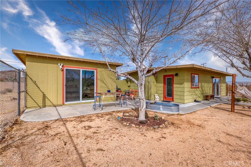 Discover the charm of this 2-bedroom, 1-bath home in north Joshua Tree, where thoughtful design meets the serene beauty of the desert. Sitting on a sprawling 5-acre lot, this 748-square-foot home is less than 15 minutes from the iconic Joshua Tree National Park, offering easy access to endless outdoor adventures.
Inside, the home boasts wood-look tile flooring throughout and zoned mini-splits for comfortable cooling. The kitchen is both functional and stylish, featuring quartz counters, a stainless steel electric stove, fridge, dishwasher, and oven vent hood. The bathroom combines simplicity and elegance with a tile backsplash and a shower-in-tub setup. The property includes a separate outbuilding, as well. Yard is FULLY fenced!
This property was previously a short term rental, but has been used as a long term rental recently. Thanks to its inviting aesthetic and highly photogenic spaces—perfect for capturing the magic of desert living, this could make a fantastic rental property again. Whether you’re an aspiring homeowner or looking to create a getaway that guests will love, this home is ready to impress.
Beyond the home, the Joshua Tree area is a haven for creativity and exploration. Enjoy the vibrant local art scene, live music at Pappy & Harriet’s, and events like the Joshua Tree Music Festival. For nature enthusiasts, hiking, stargazing, and rock climbing are just the beginning of the adventures awaiting you.
This home has been lovingly maintained, offering a peaceful retreat or an opportunity to share the desert’s allure with others.