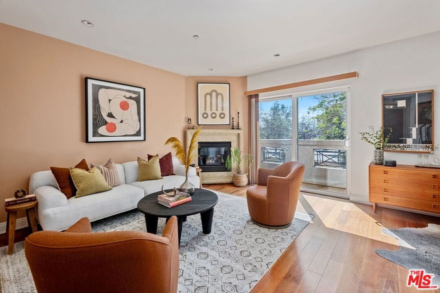 A townhome in a boutique building of only 10 units! This premier unit, built in 2009, features three levels with balconies offering treetop and mountain views, and plenty of natural light throughout. The kitchen includes granite countertops, travertine floors, and stainless steel appliances. It opens to the living and dining areas, making the space ideal for both daily living and entertaining.  The living room features a stone fireplace, wood floors, iron stair rails, and recessed lighting. There's also a powder room on the entry level. The secondary bedrooms are located on the middle level and offer generous space, sharing a full hallway bathroom. This floor also includes a laundry area that fits a full-size stackable washer and dryer. The oversized primary bedroom occupies the top level and includes an ensuite bathroom with a separate shower, large soaking tub, dual sinks, and a walk-in closet. One of the two balconies is partially enclosed for added privacy. The building features with gated entry to an interior courtyard and gated two side-by-side parking spaces with Tesla car charger. HOA dues are $498 per month, includes earthquake insurance, and balconies have been inspected.  Located in a convenient Valley Village location, close to the Metro and the North Hollywood Arts District.